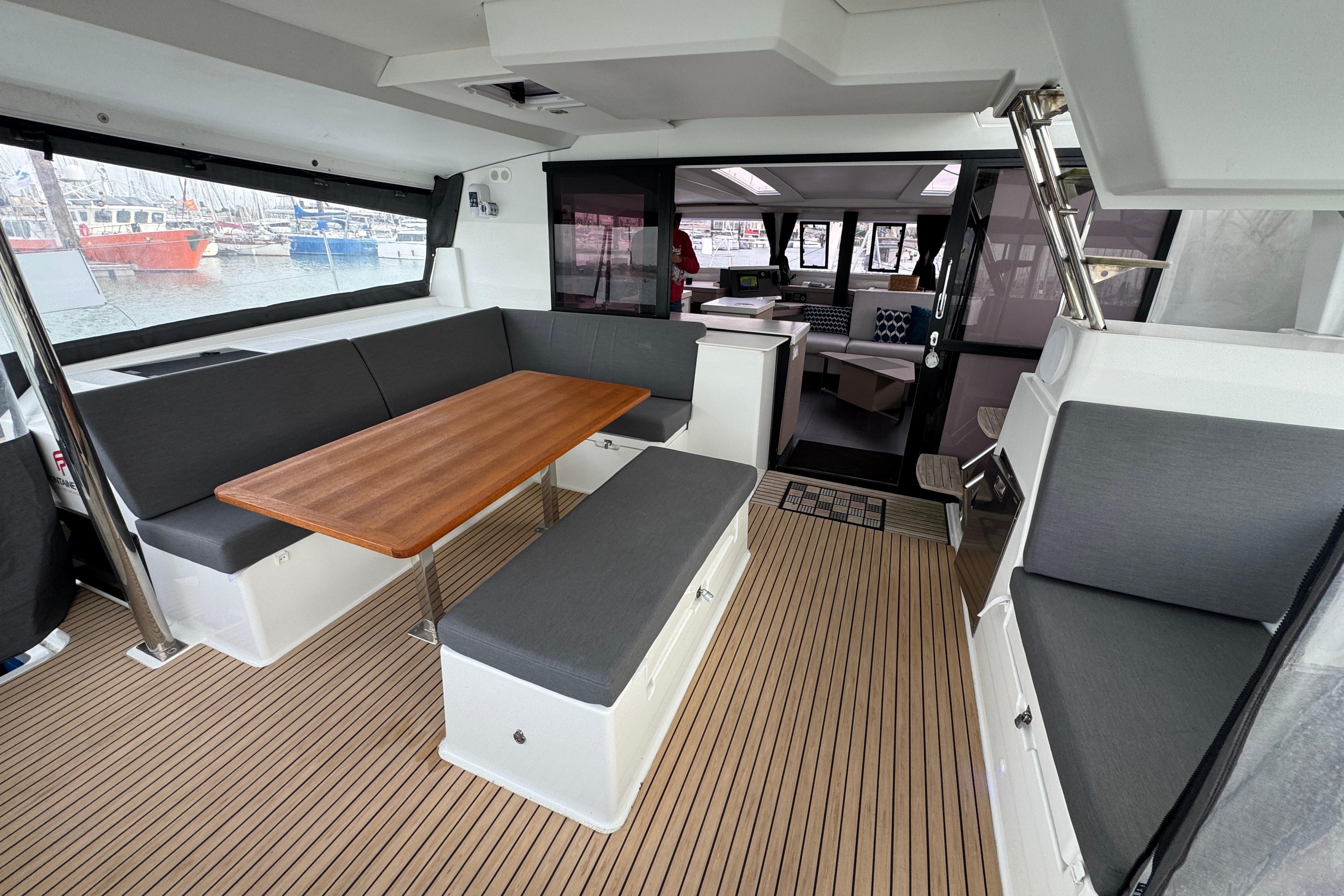 Interior of 2021 Fountaine Pajot Saona 47 catamaran with modern seating and wooden table.