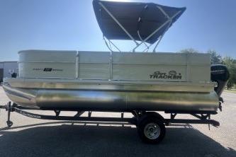 2026 Sun Tracker Party Barge 18 DLX pontoon boat with canopy on trailer.