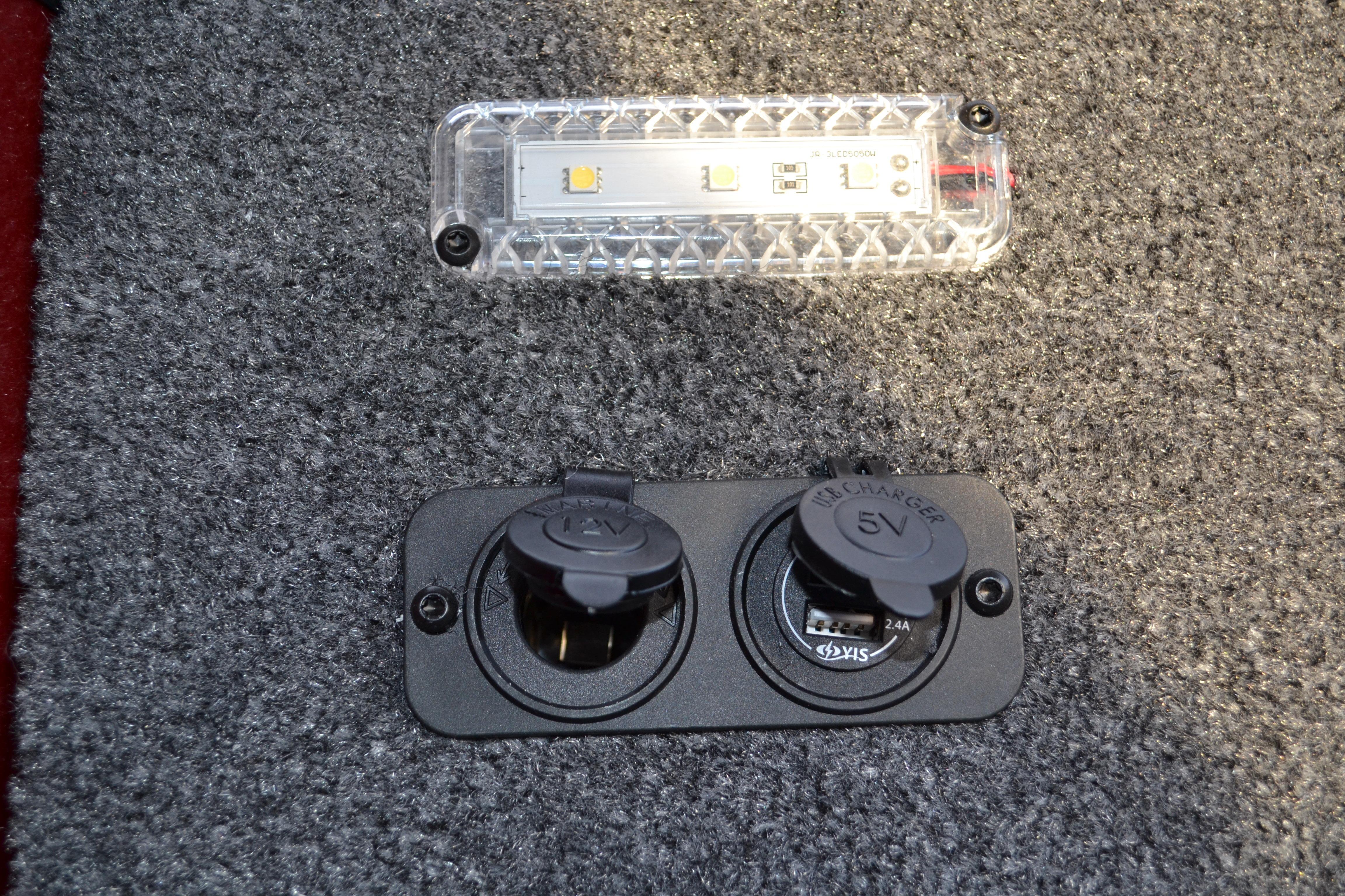 LED light and dual USB charger on 2026 Ranger RT188 boat carpet.