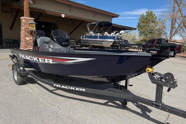 2026 Tracker Super Guide V-16 SC boat on trailer, parked outdoors.