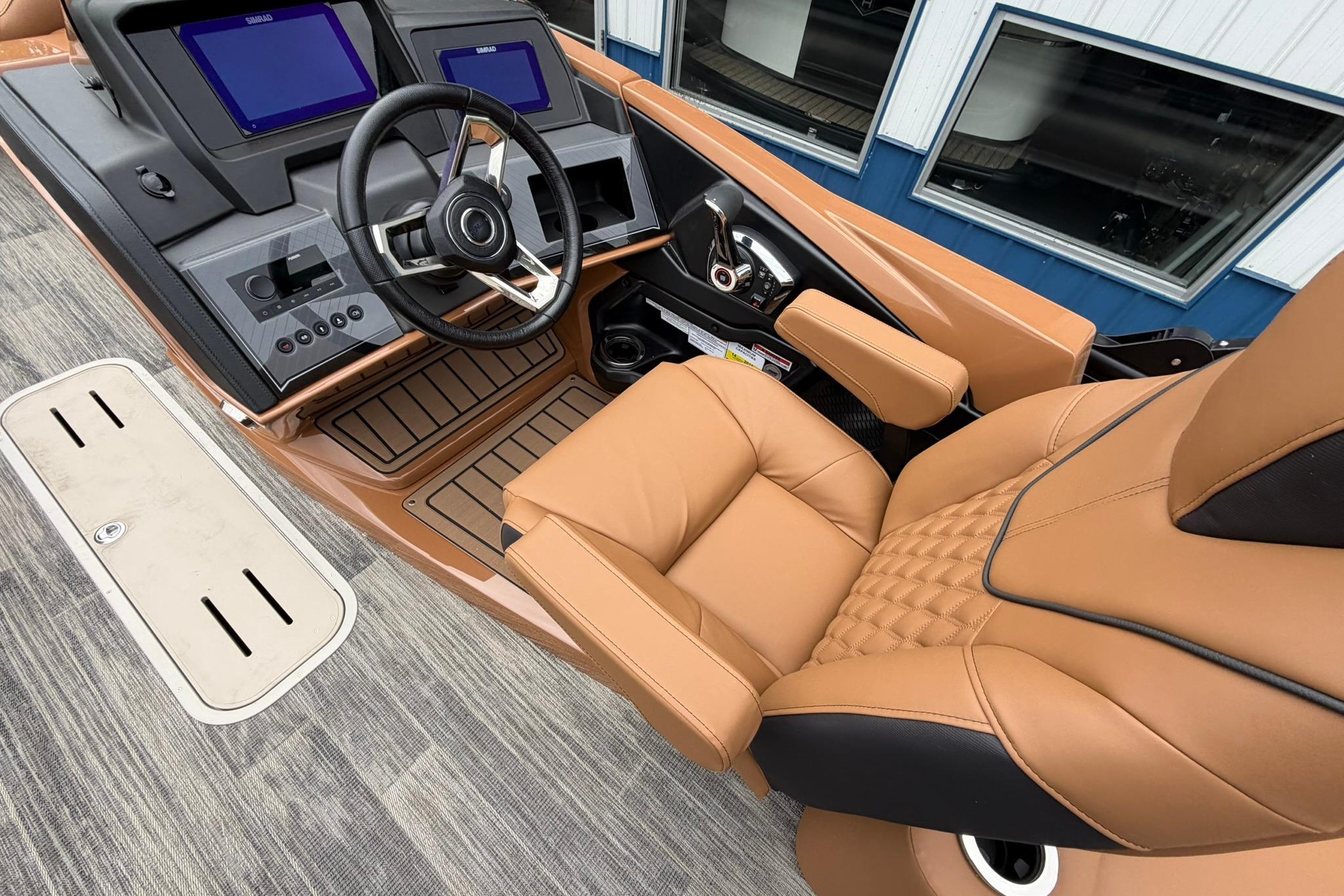 Luxurious helm of 2026 Avalon Catalina Quad Lounge Shift boat with leather seating and modern controls.