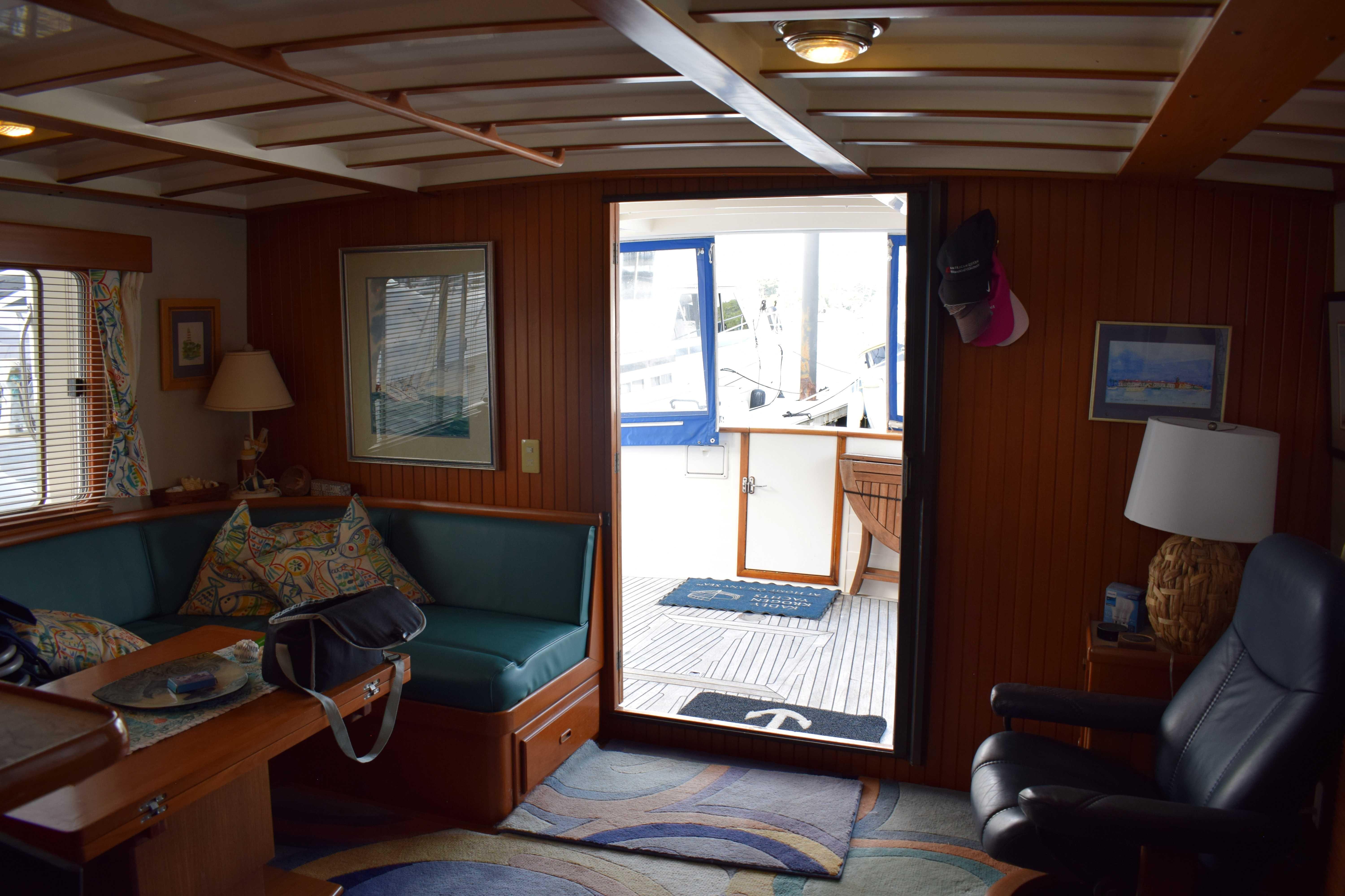 Interior of 2001 Kadey Krogen 48 yacht with cozy seating and nautical decor.