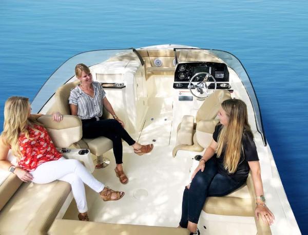 Three people relaxing on a 2025 Scout 215 Dorado boat, enjoying a sunny day.