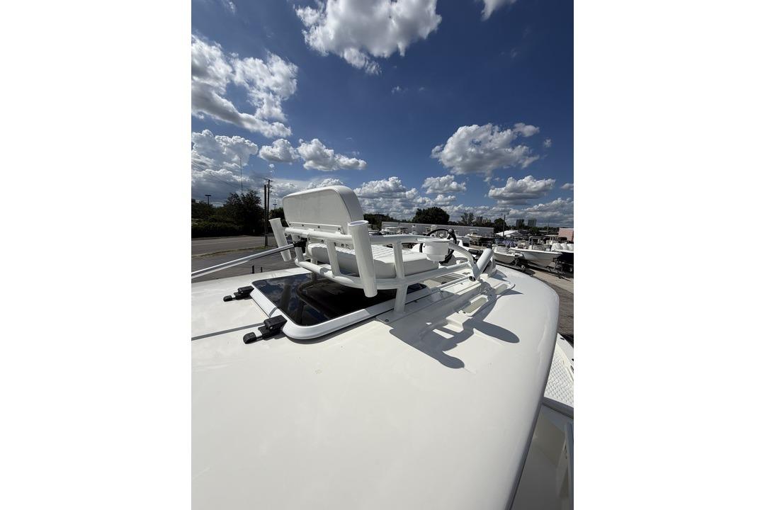 2026 Pathfinder 2800 Hybrid boat rooftop with chair under a cloudy sky.