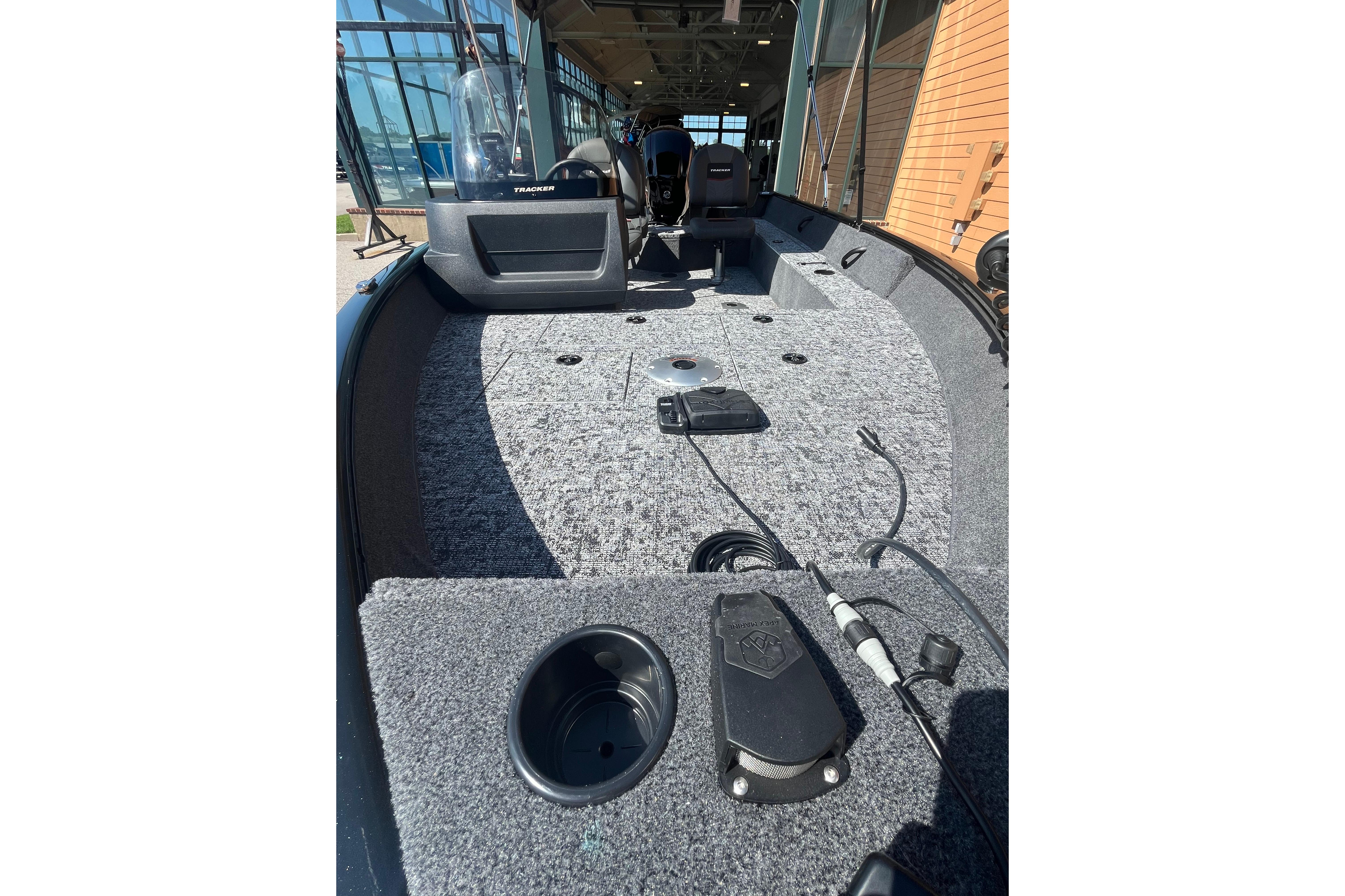 2026 Tracker Pro Guide V-16 SC boat interior with carpeted deck and console view.