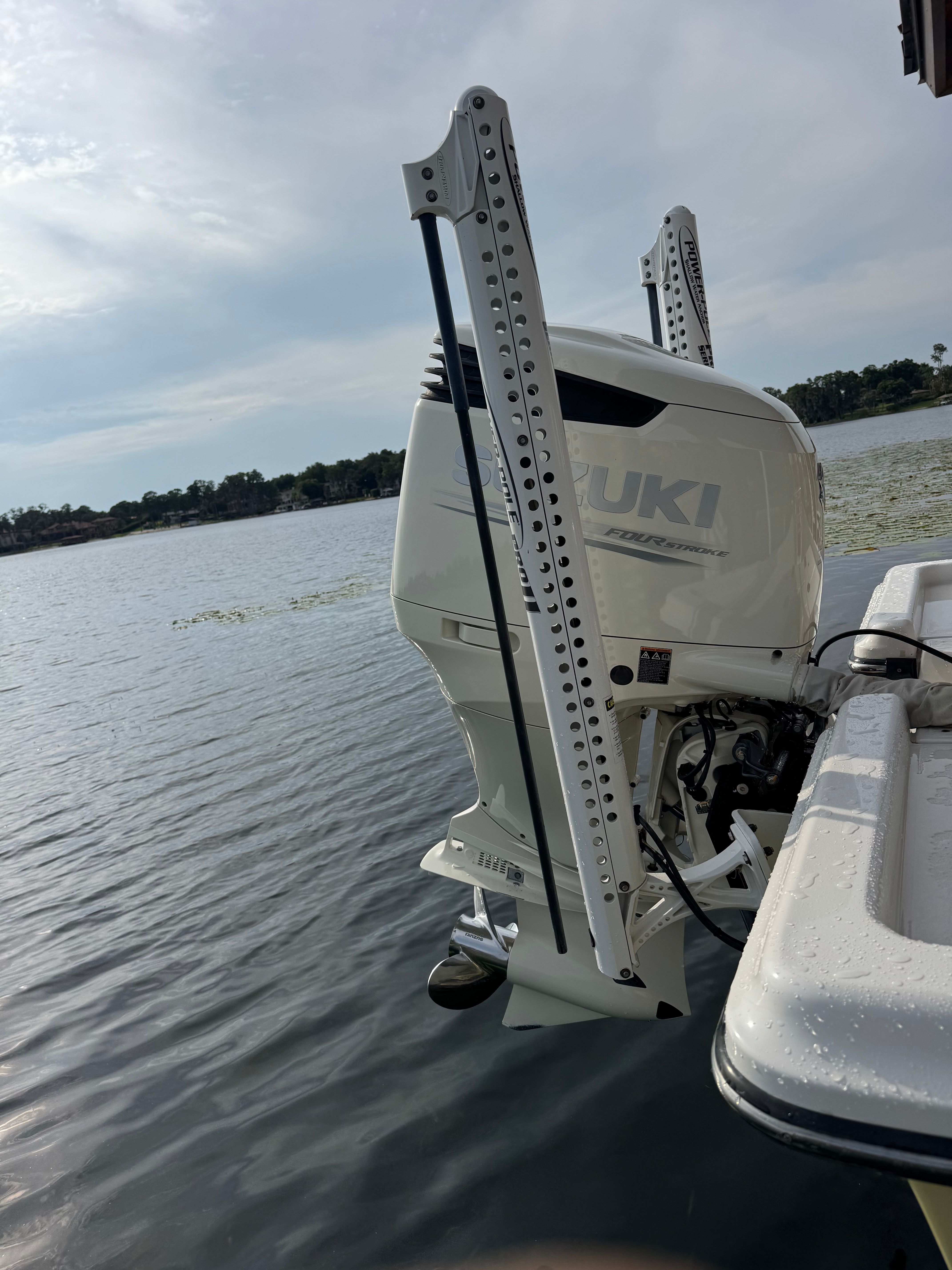 ShearWater LTZ 2004 boat with Suzuki outboard motor on calm water.