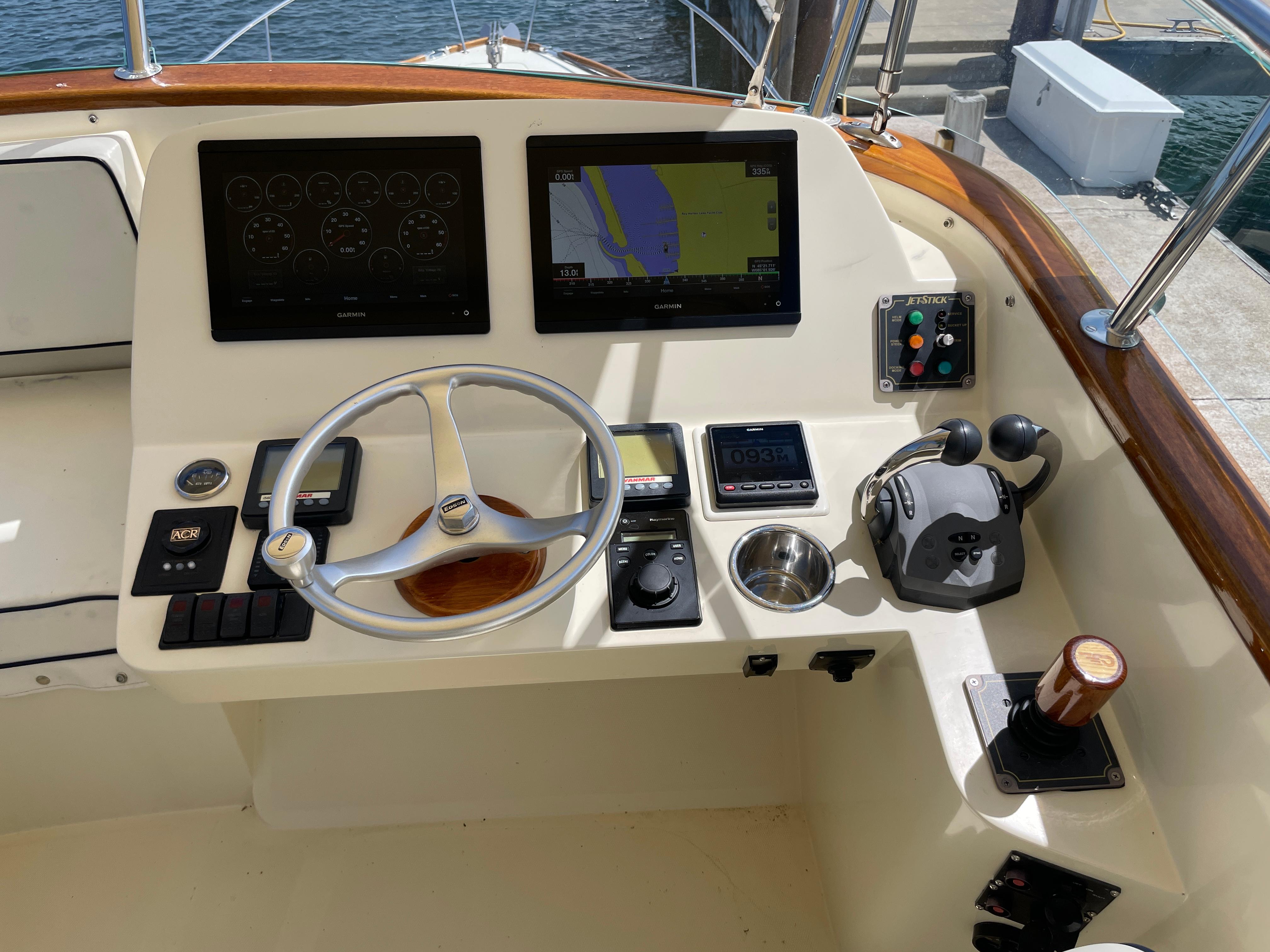 Helm of 2007 Hinckley Talaria 44 Flybridge with navigation screens and controls.