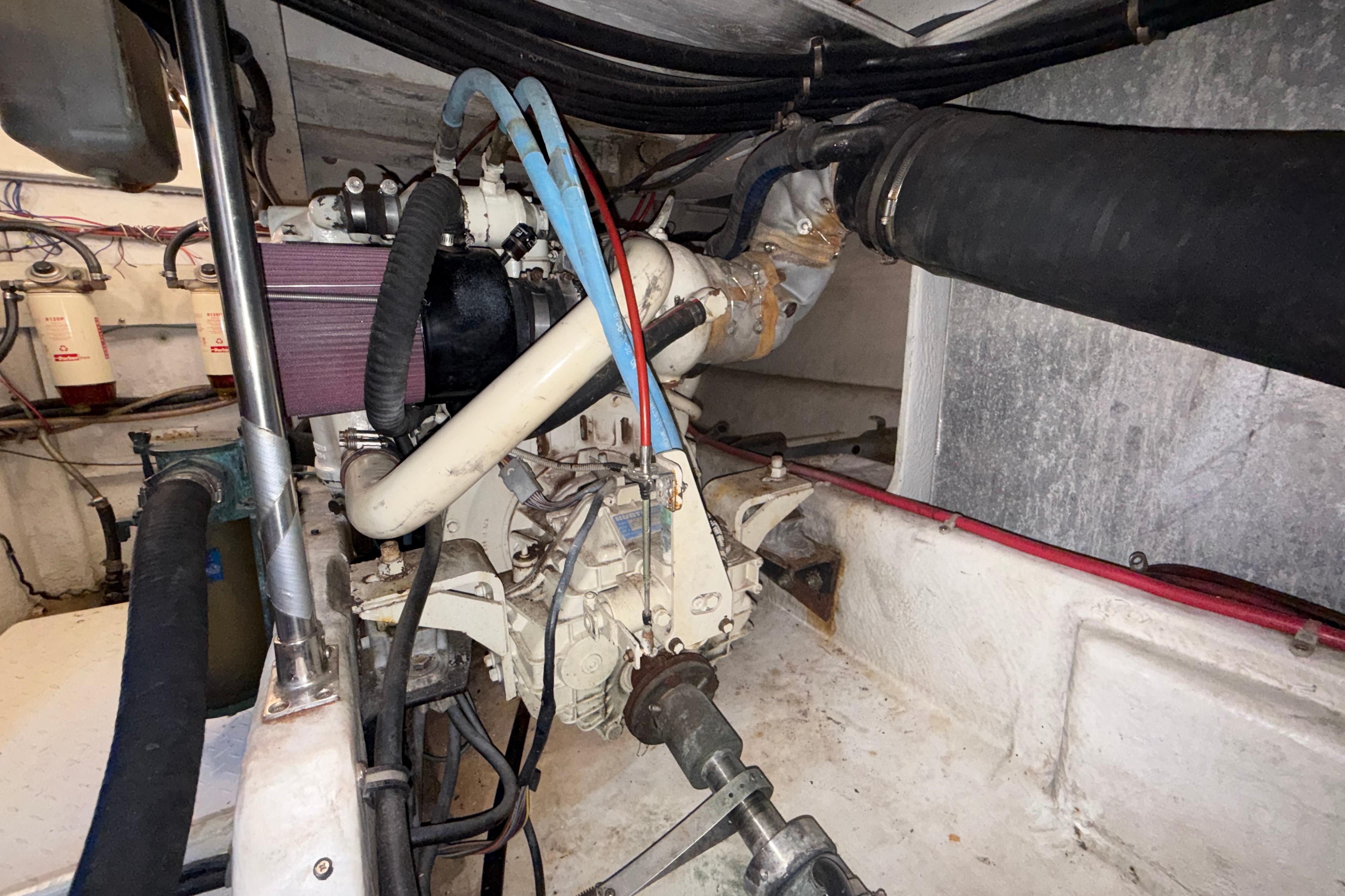 Engine room of a 1997 Bayliner 3988 Command Bridge Motoryacht, showcasing mechanical components.