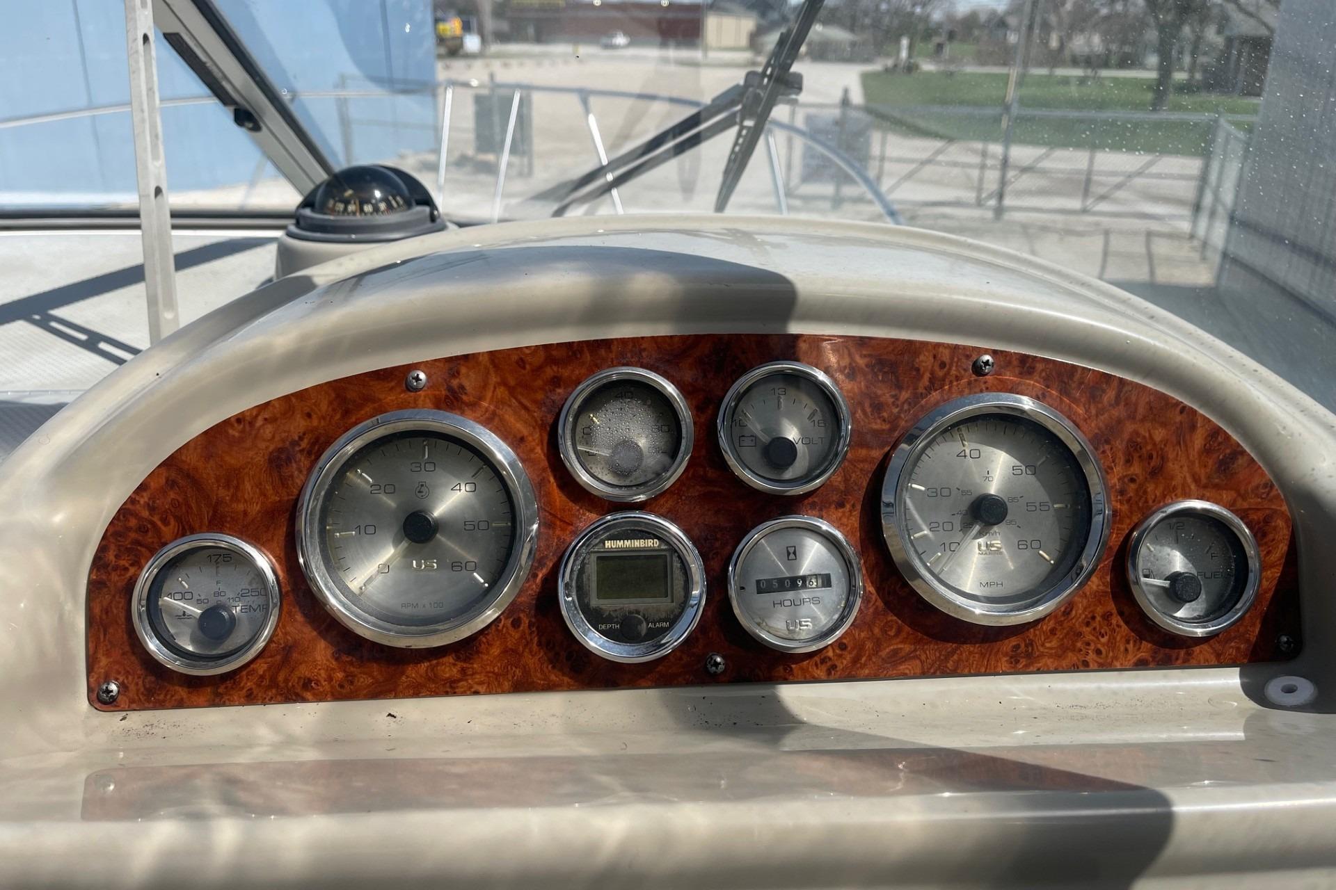 Dashboard of a 1997 Bayliner 2655 Ciera boat with gauges and controls.