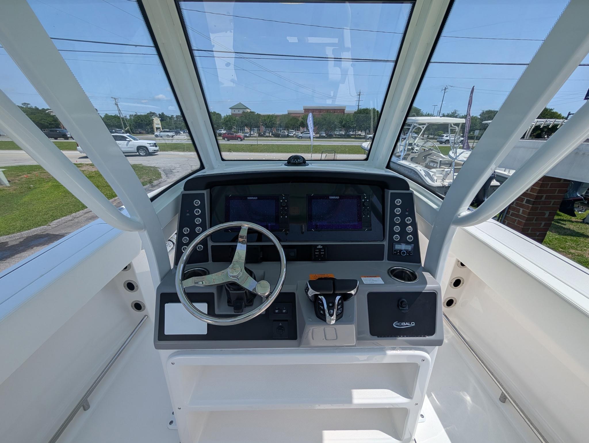 2025 Robalo R250 Center Console boat helm with steering wheel and navigation displays.