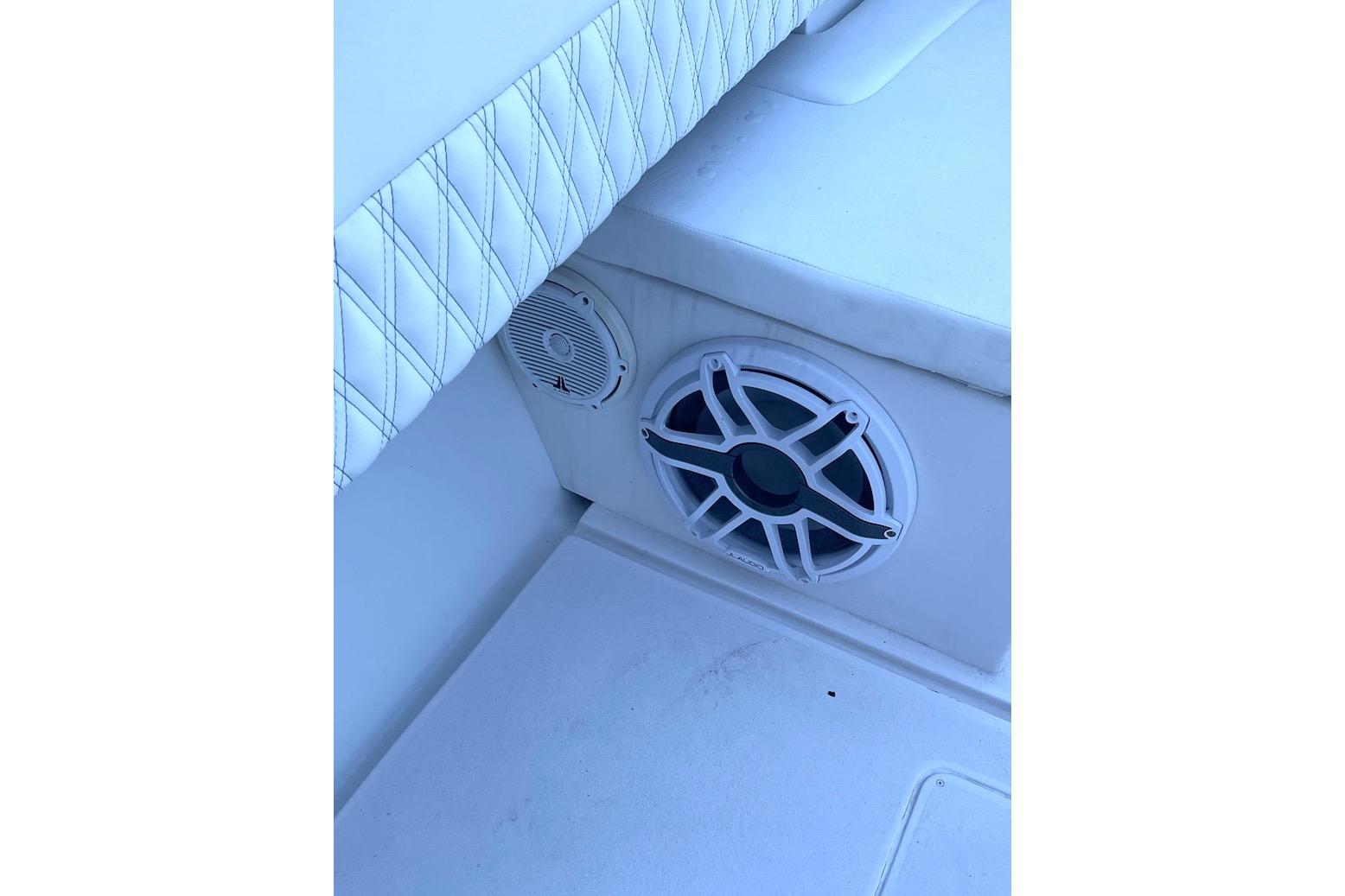 Speaker system on a 2002 Intrepid 323 Cuddy boat with cushioned seating.