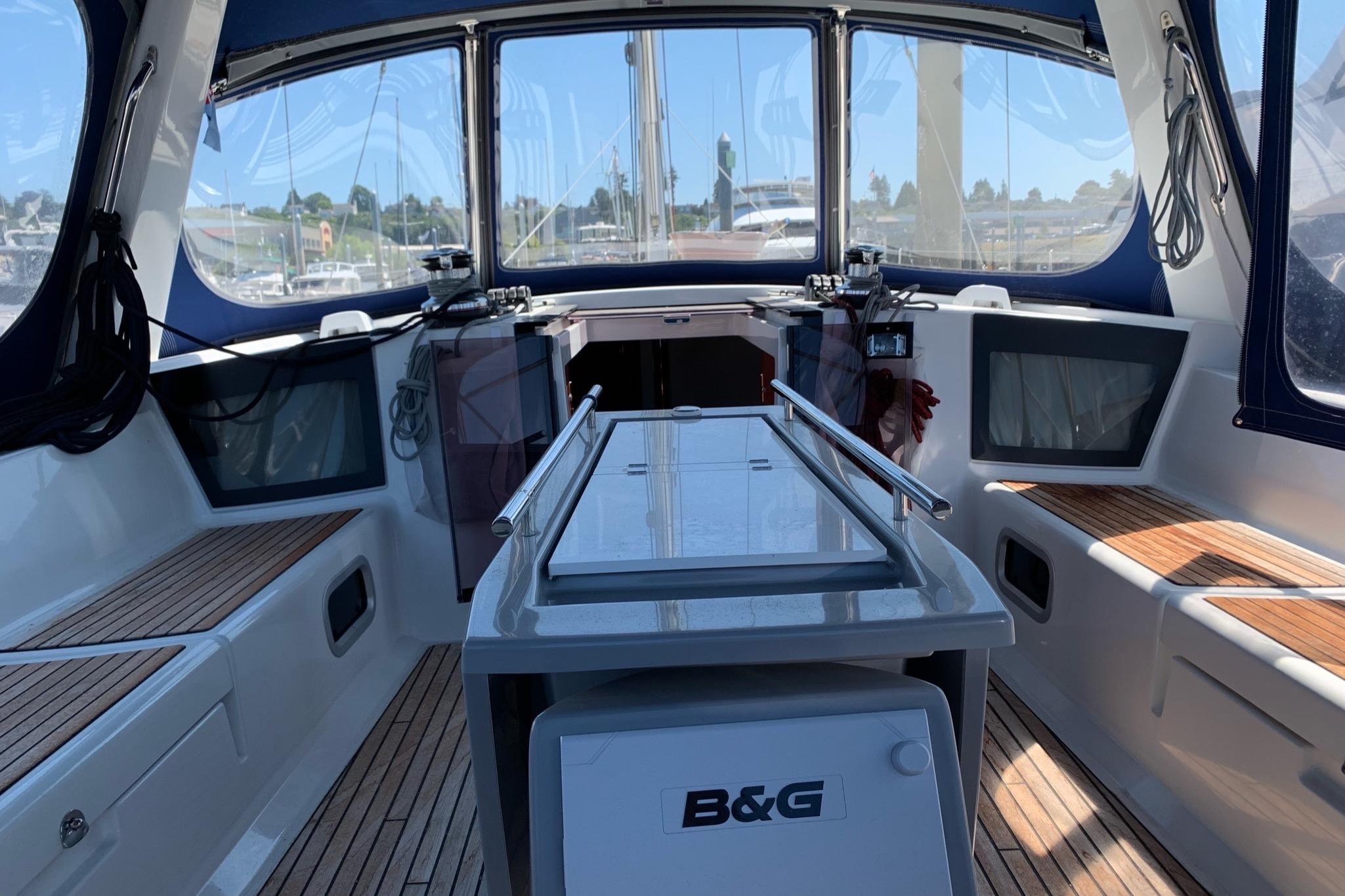 2018 Beneteau Oceanis 45 yacht cockpit with teak seating and navigation equipment.