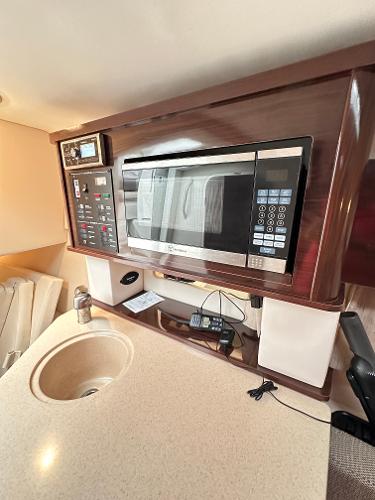 2015 Sea Ray 260 Sundancer interior with microwave and control panel.
