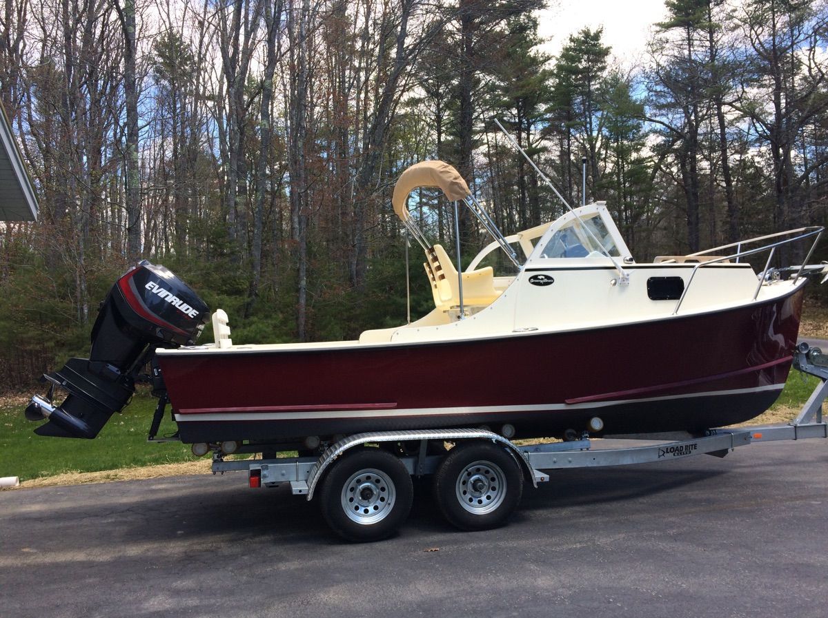 A 2018 Seaway Seafarer 21 boat on a trailer, surrounded by trees.