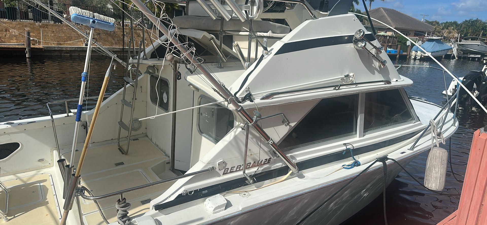 1974 Bertram 28 boat docked, side view.