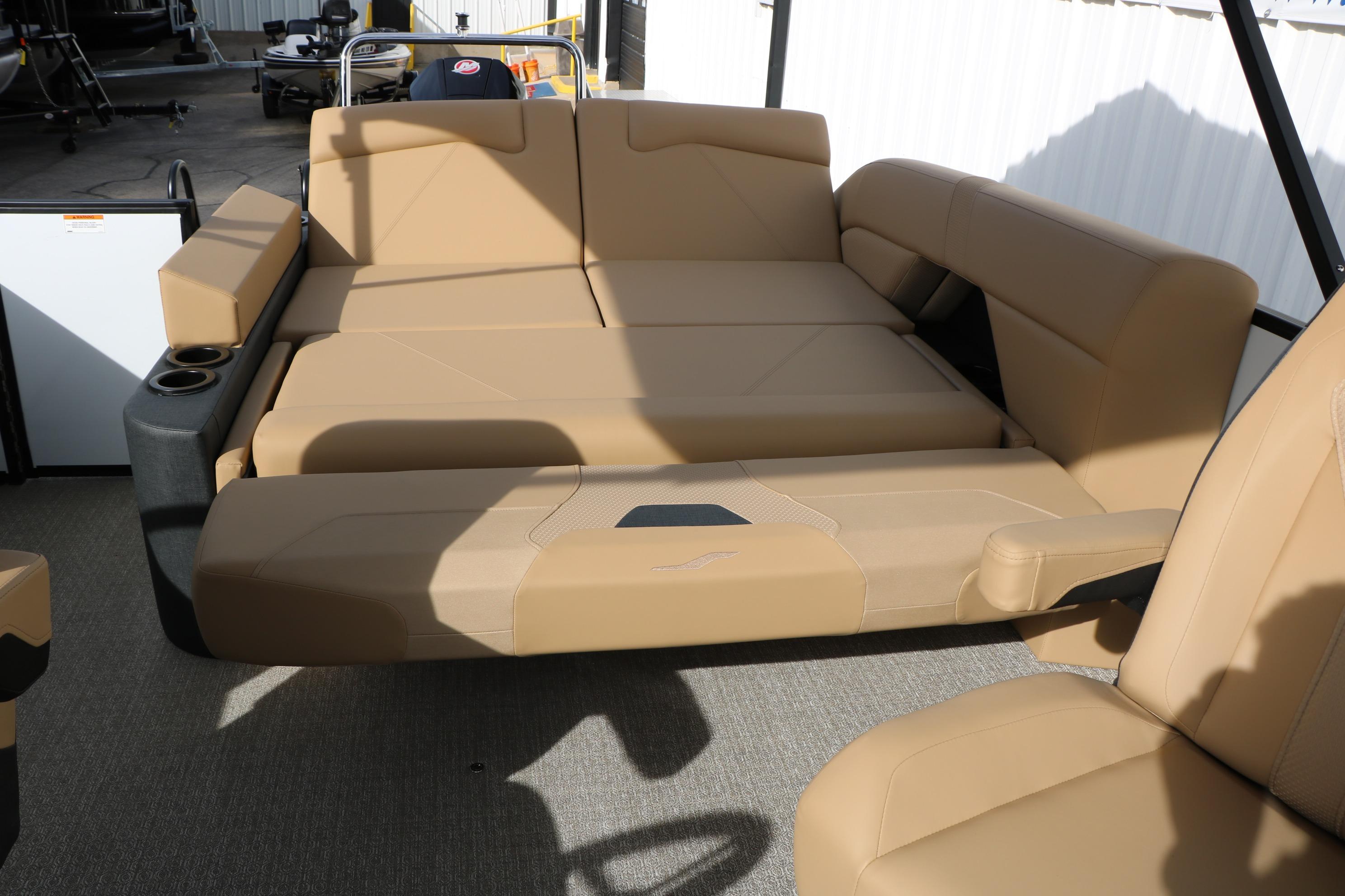 Luxurious seating on 2026 Evotti 523CS boat, featuring tan upholstery and cup holders.