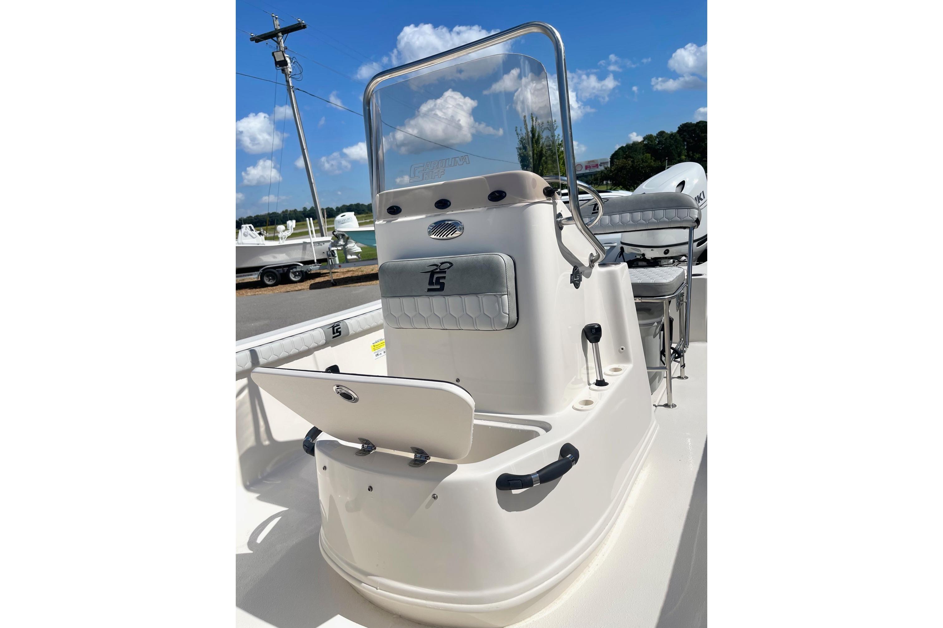 2026 Carolina Skiff 19 LS boat console with seating, outdoors under blue sky.