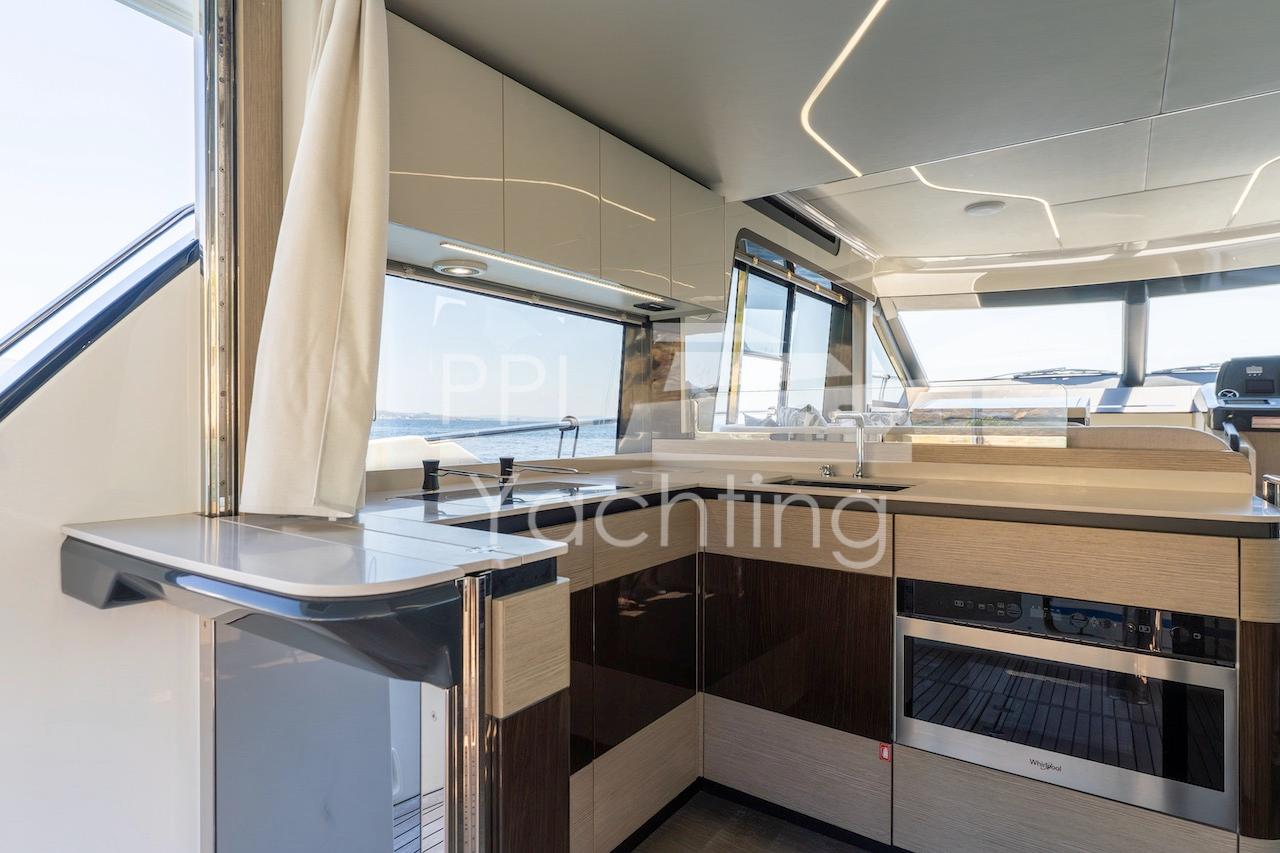 Modern kitchen interior on 2021 Absolute 47 Fly yacht, featuring sleek cabinetry and appliances.
