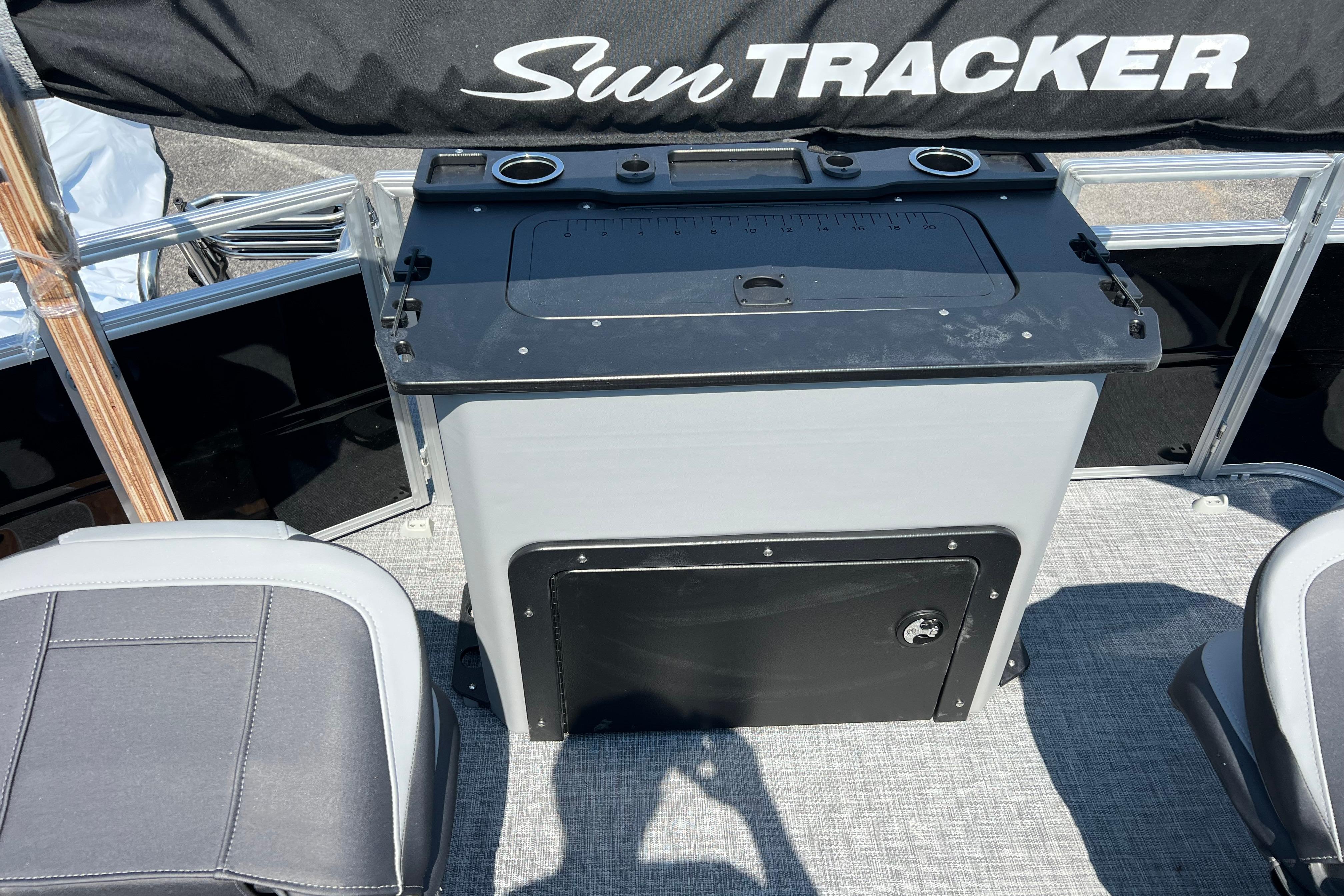 2026 Sun Tracker SportFish 20 DLX boat interior with seating and storage area.
