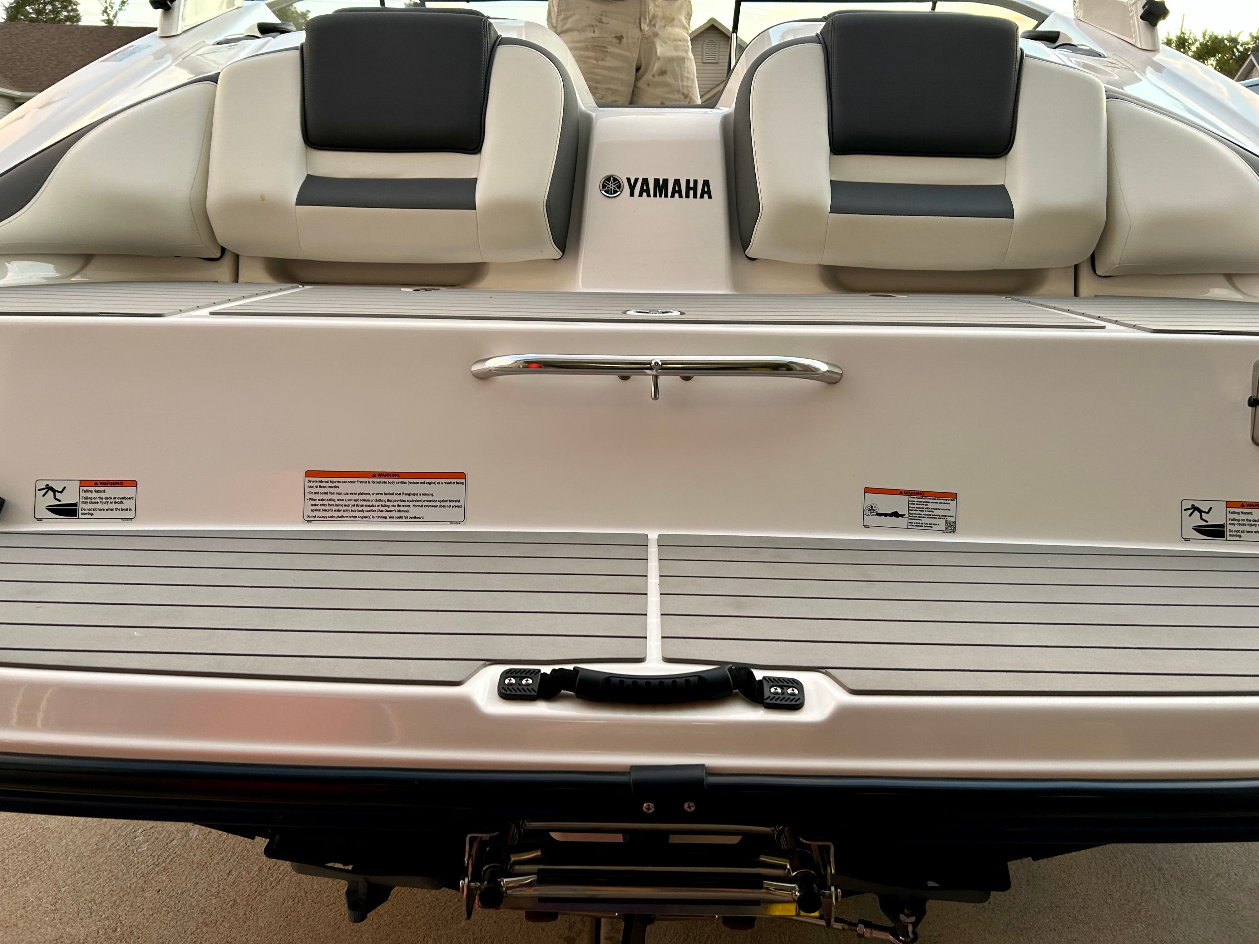 The image shows the rear of a Yamaha AR210 boat with two seats and a handle.