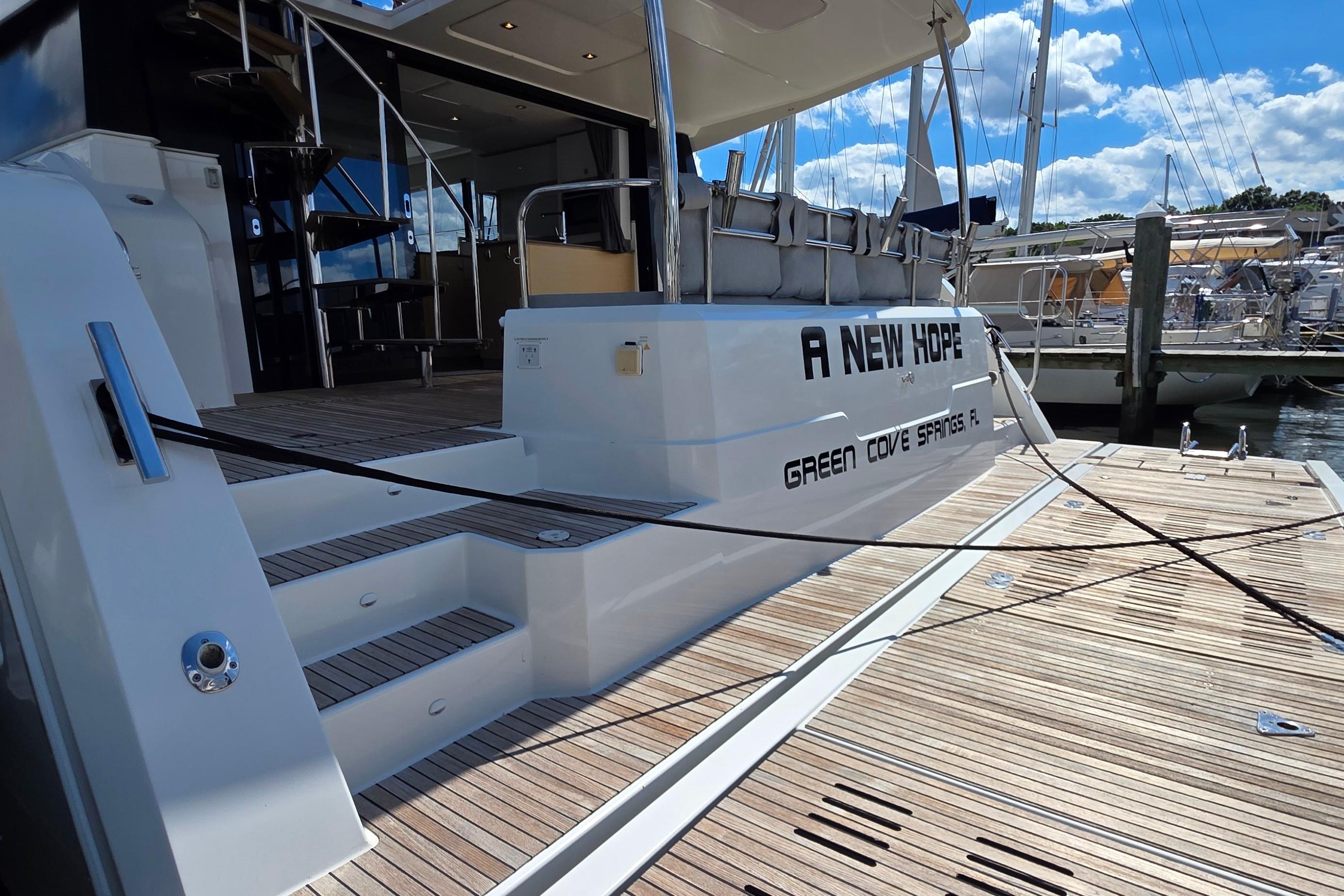 Fountaine Pajot Motor Yacht 44, 2018, docked with wooden deck and stairs.