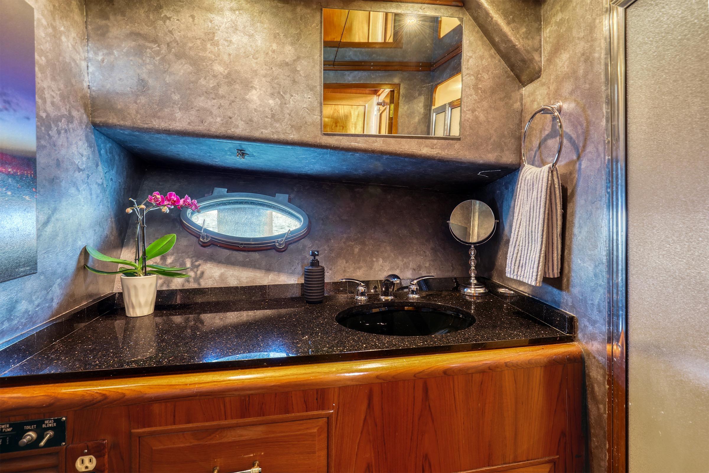 Luxurious bathroom interior of 1987 Ocean Alexander 480 Sport Sedan yacht with elegant fixtures.