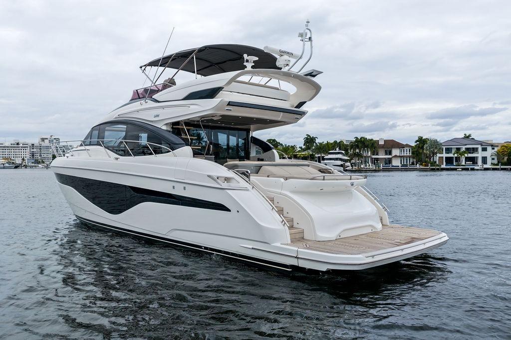 Luxurious 2020 Princess S62 yacht on calm water, showcasing sleek design and spacious deck.