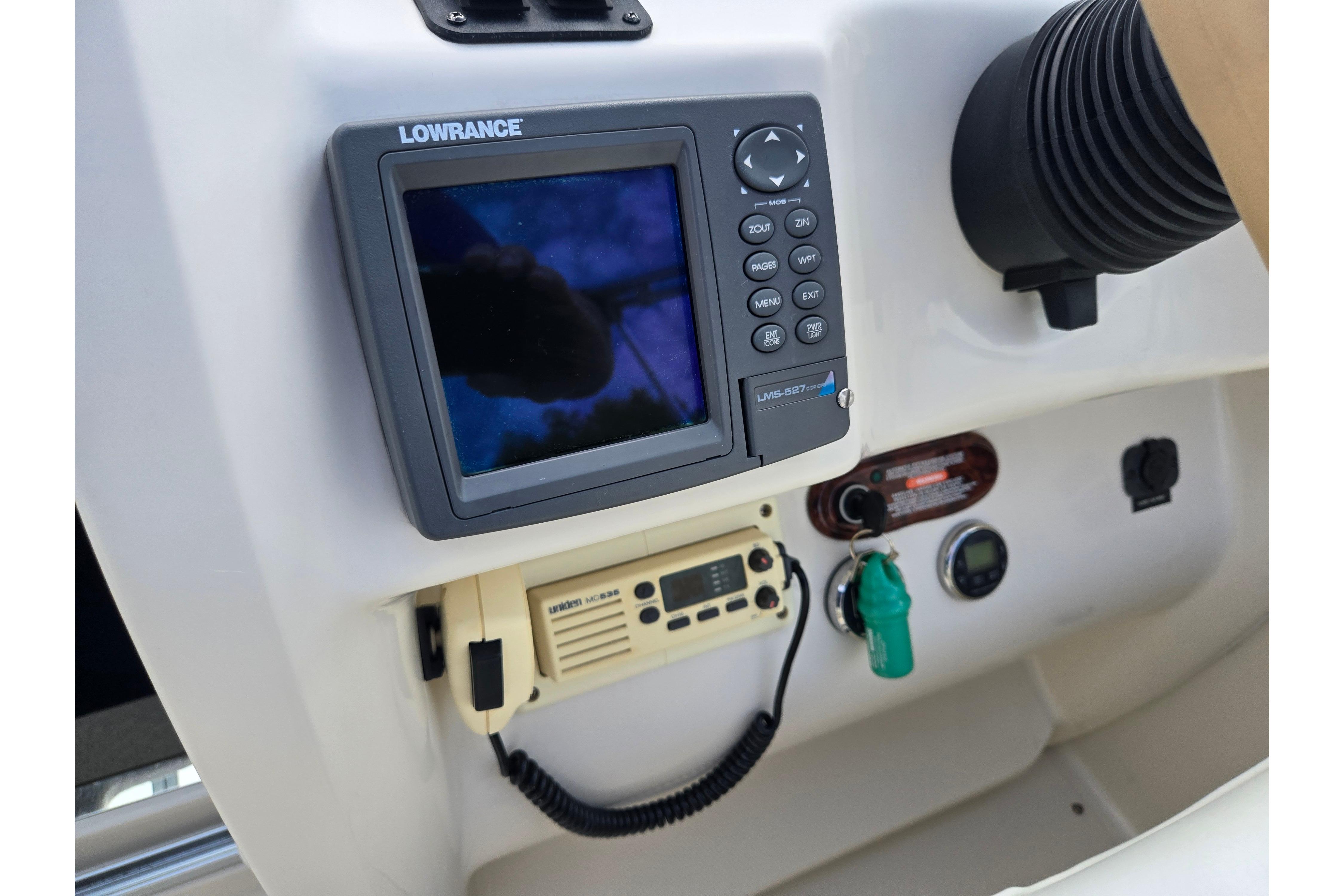 Control panel of 2002 Sea Ray 225 Weekender with Lowrance navigation system and radio.