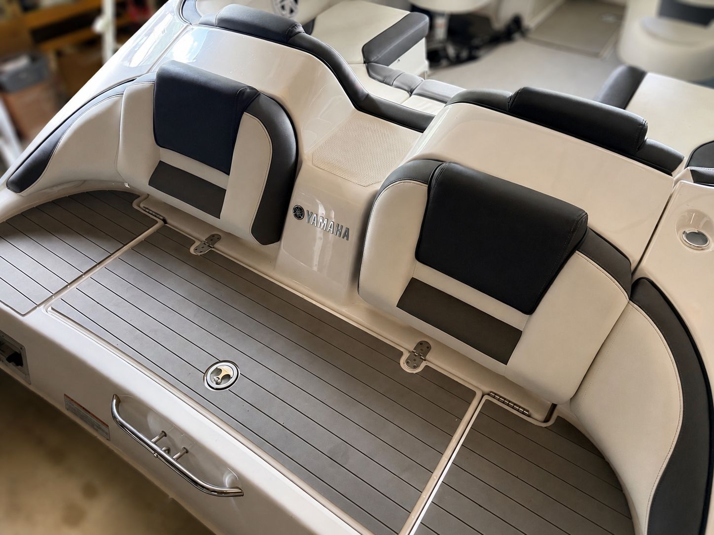 The image shows the stern of a 2021 Yamaha SX210 boat with cushioned seating.