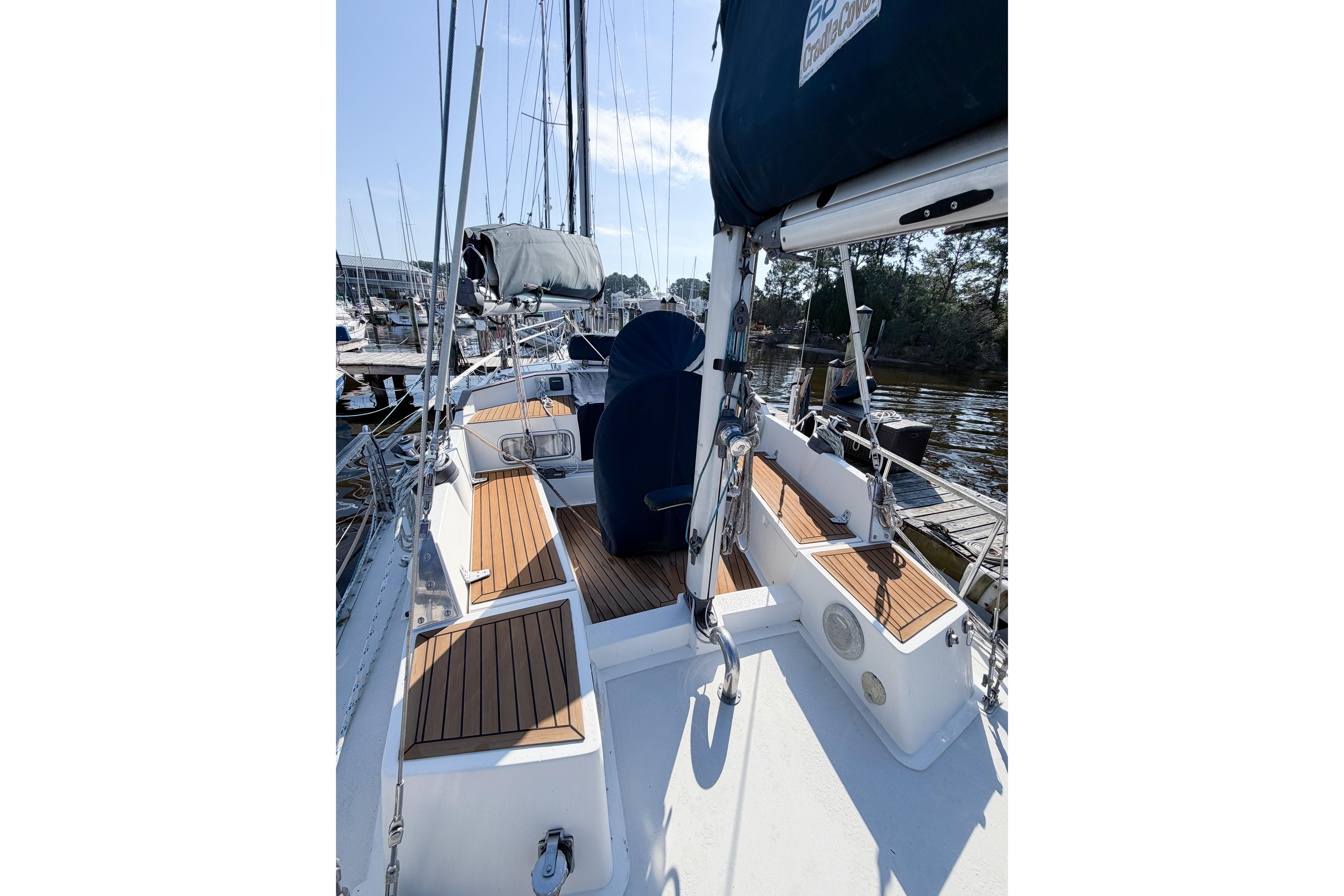 1986 Nauticat 40 sailboat deck with wooden accents, docked in a marina.