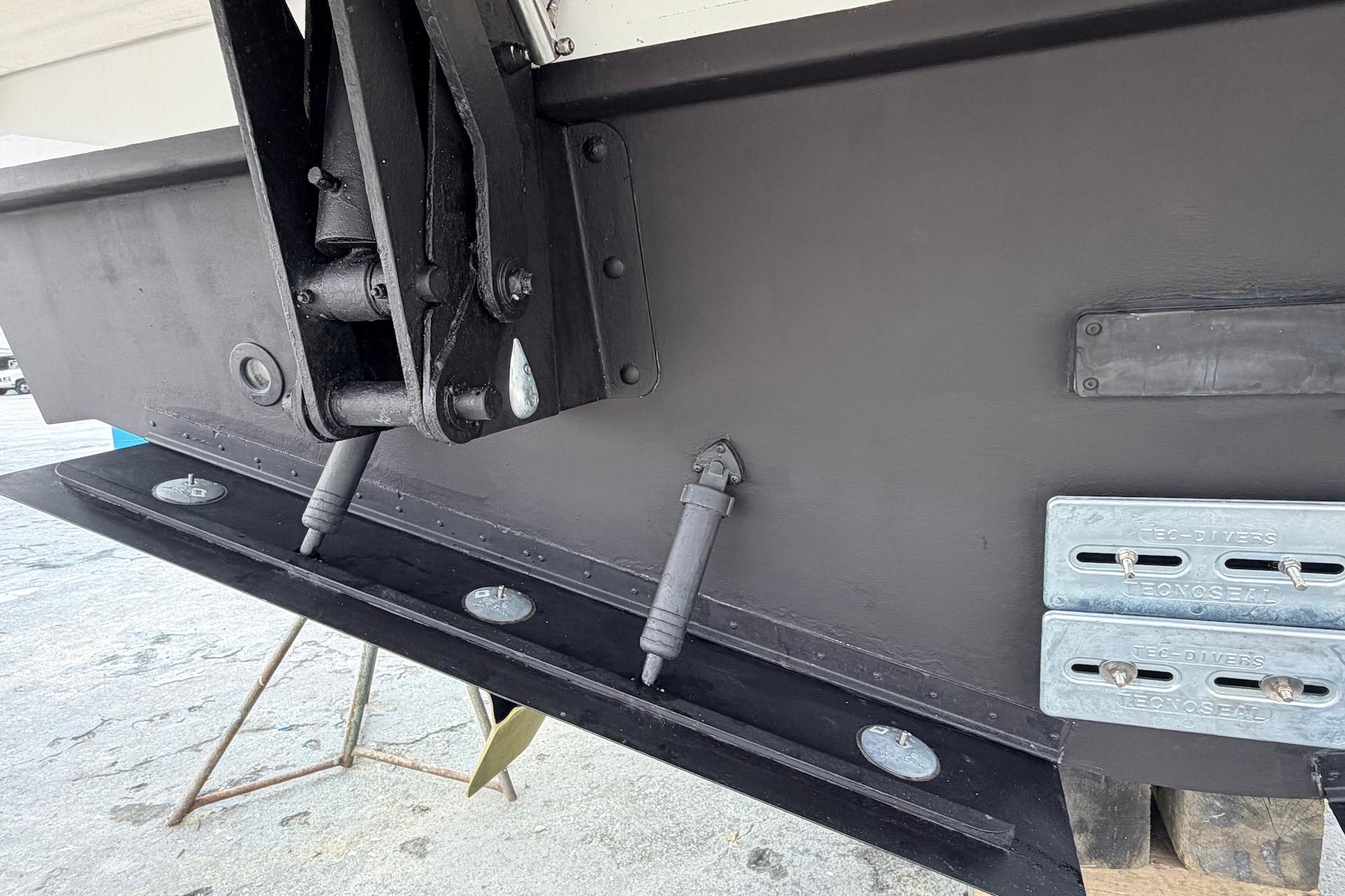 Close-up of 2022 Cruisers Yachts 42 Cantius hull with trim tabs and zinc anodes.