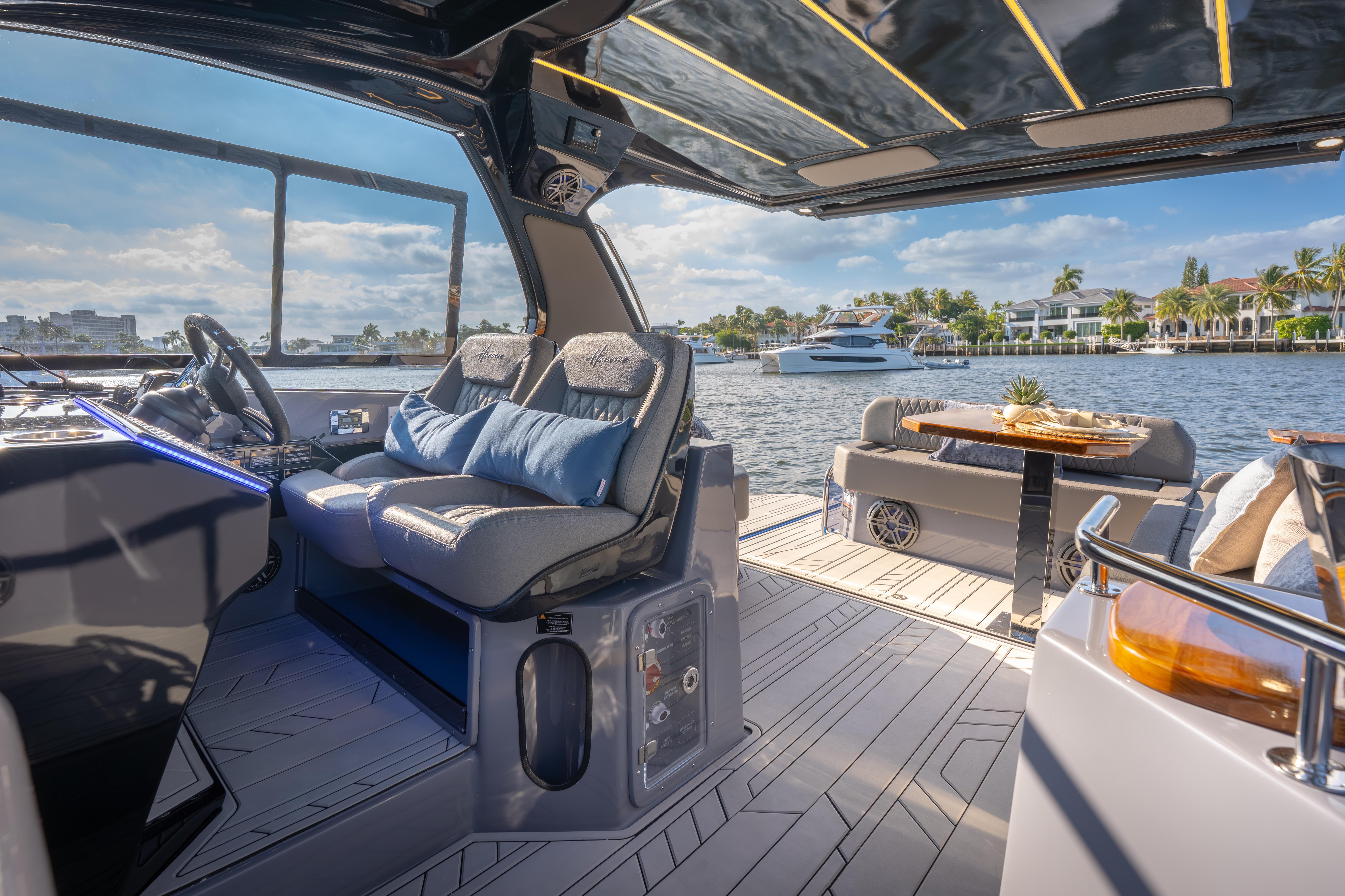 Luxurious 2026 Hanover 347 yacht interior with plush seating and scenic waterfront view.