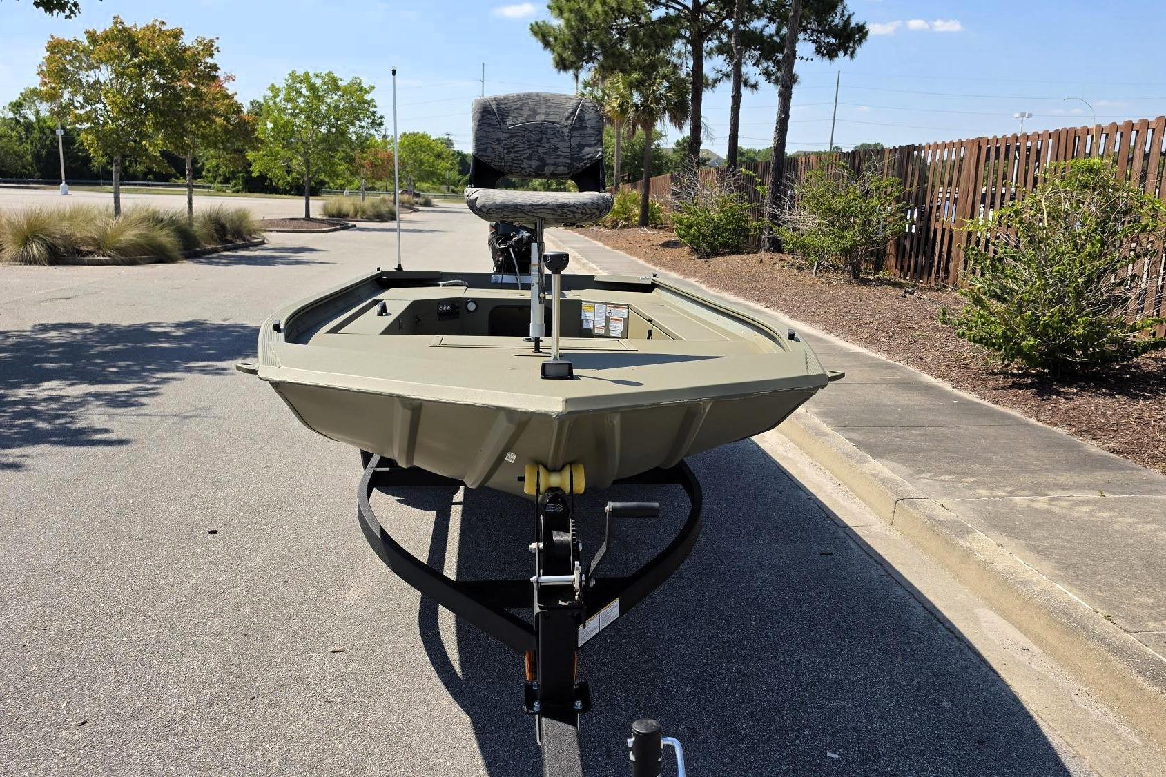 2026 Tracker Grizzly 1654 T Sportsman boat on trailer in sunny parking lot.
