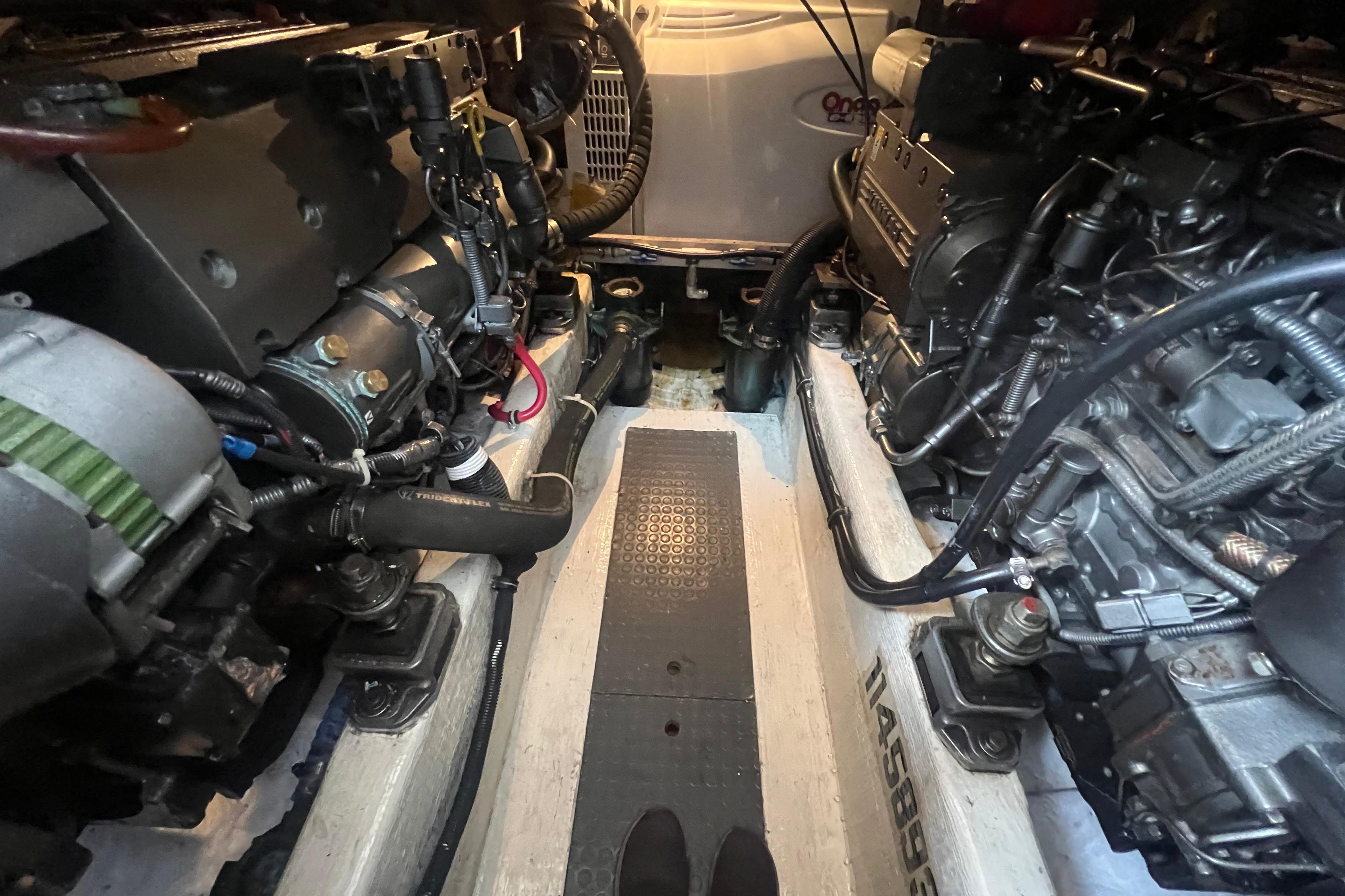 Engine room of a 2004 Sabre 36 Hardtop Sedan, showcasing dual engines and mechanical components.