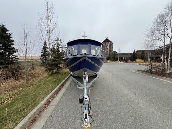 2023 Spartan 220 Maximus Pro boat on trailer in parking lot.