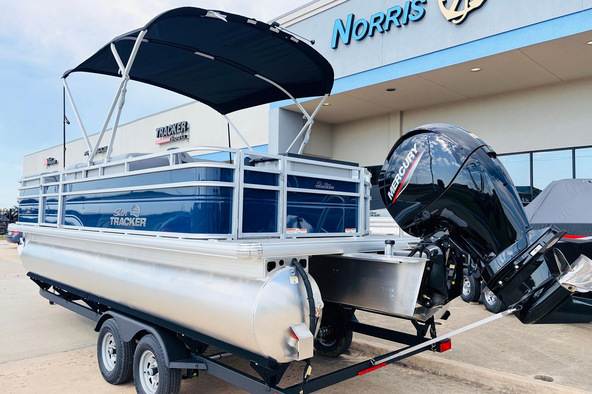 2026 Sun Tracker SportFish 22 DLX pontoon boat with Mercury engine at dealership.