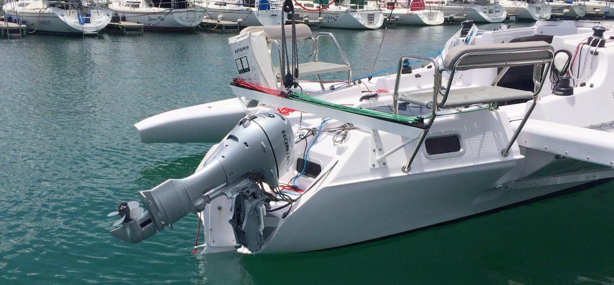 2025 Corsair 970 Sport boat docked in marina, featuring sleek design and powerful outboard motor.