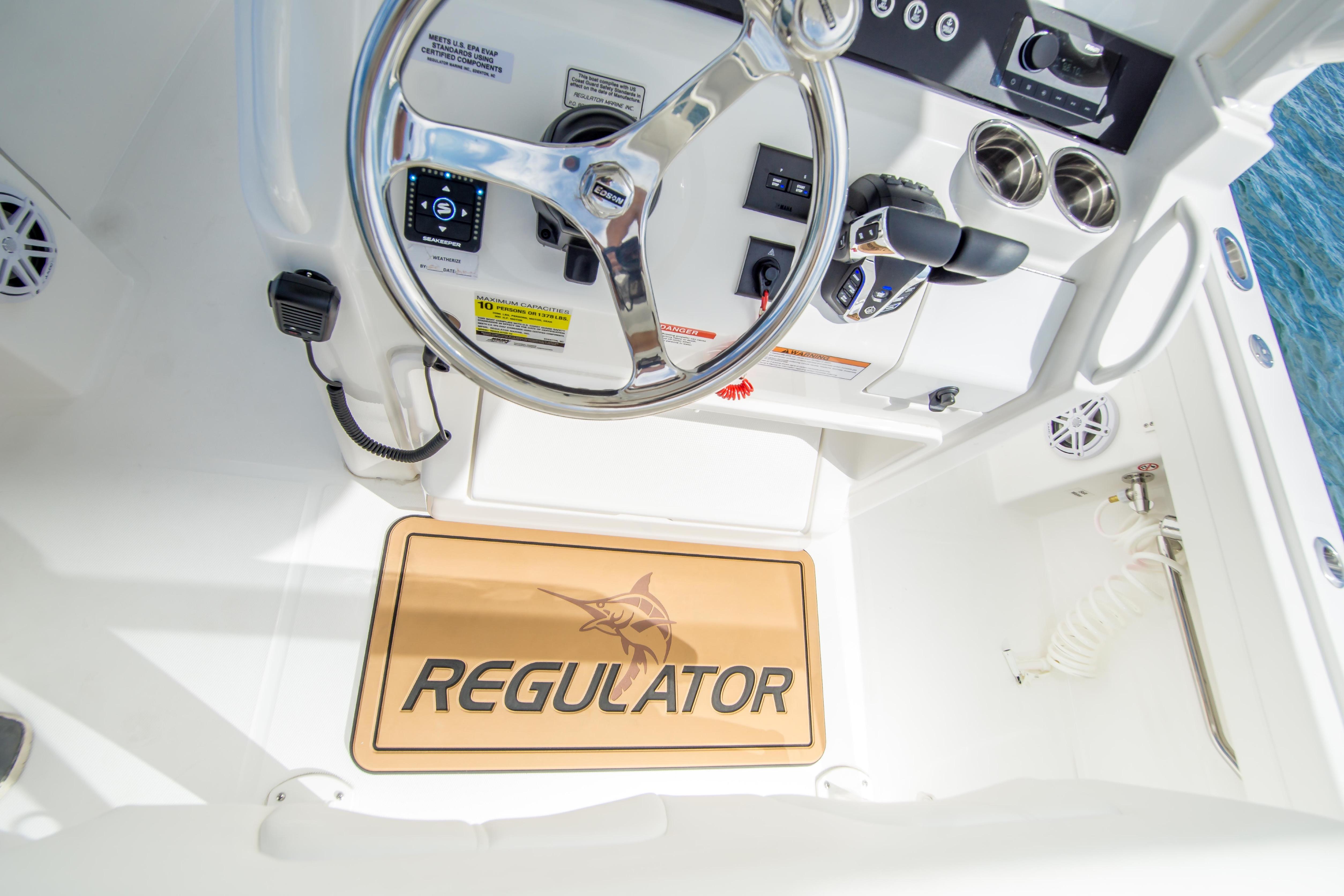 2026 Regulator 23 boat cockpit with steering wheel and control panel.