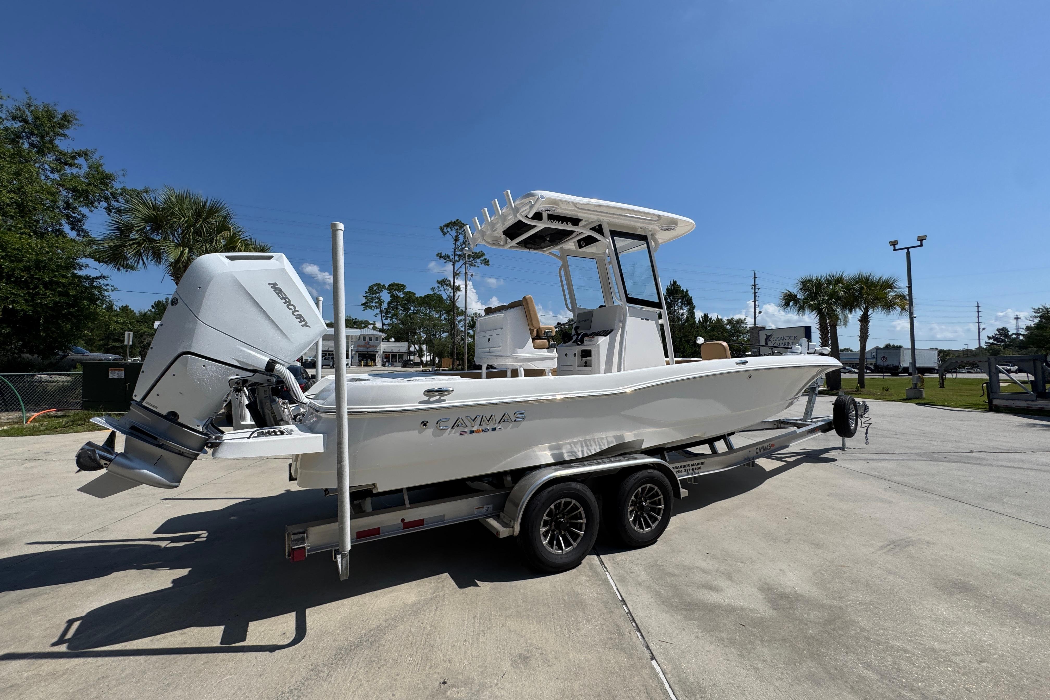 2027 Caymas 26 HB boat on trailer, featuring a powerful Mercury outboard motor.