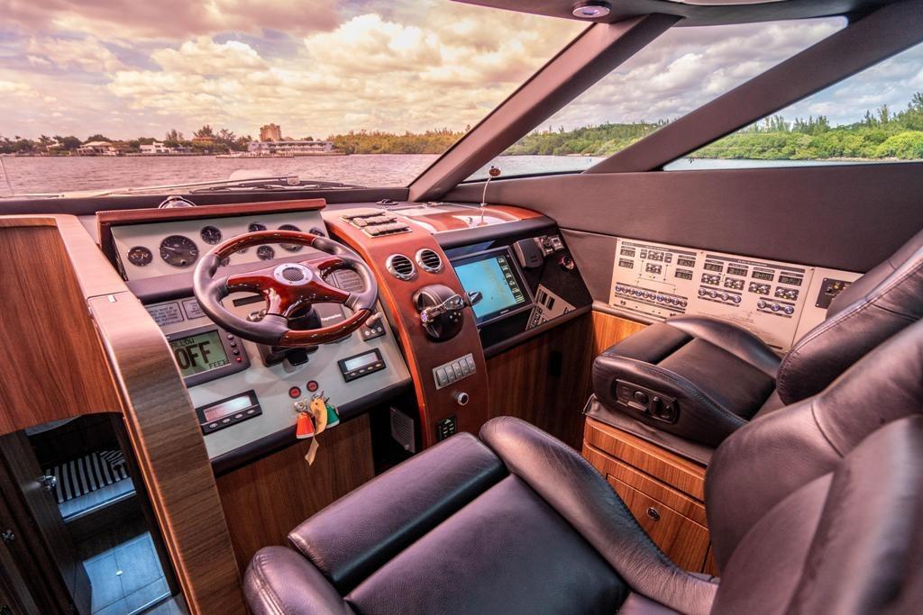 Luxurious 2020 Fairline 68 yacht cockpit with leather seats and advanced navigation controls.