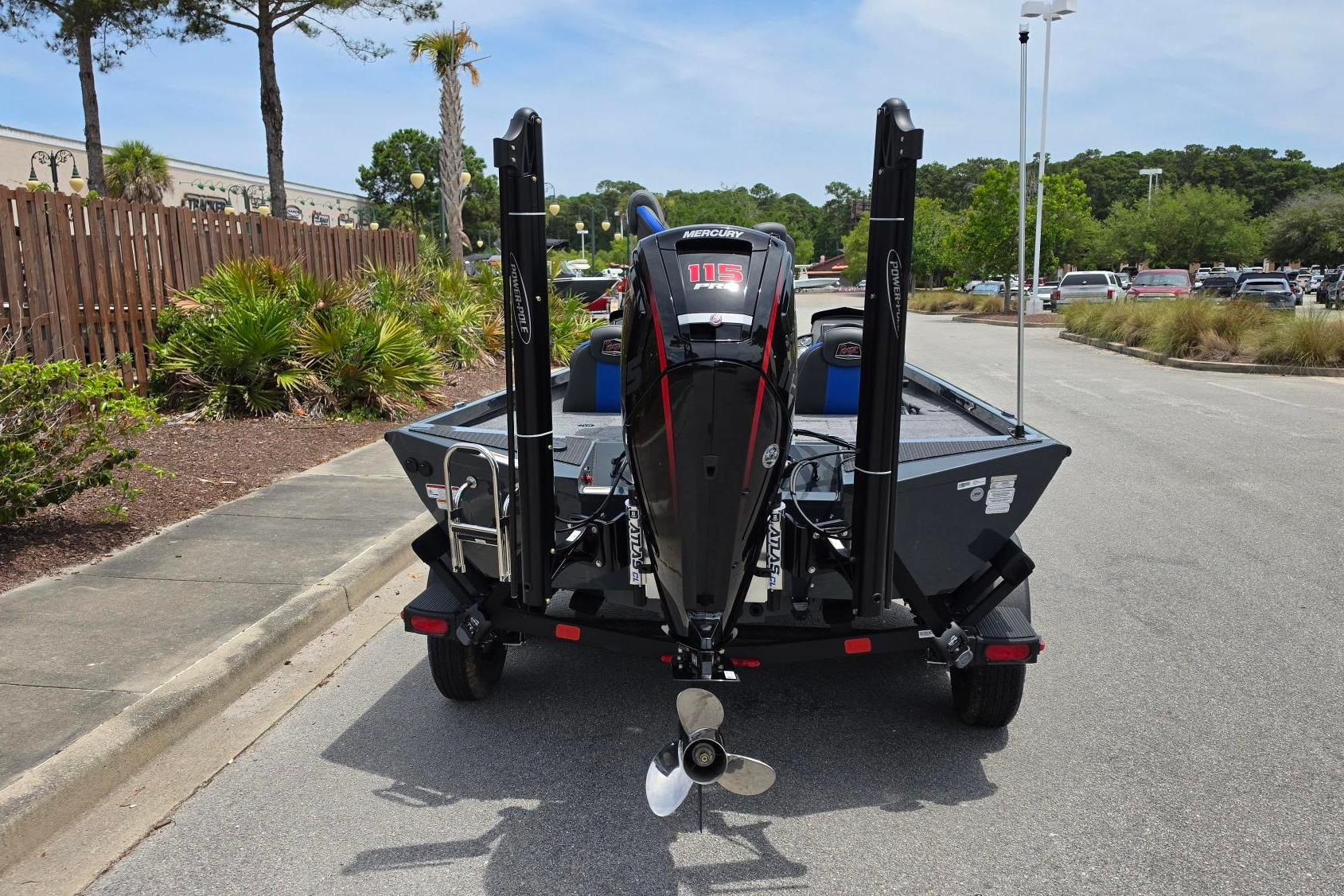 2026 Ranger RT188P boat with Mercury 115 engine, parked on a sunny street.