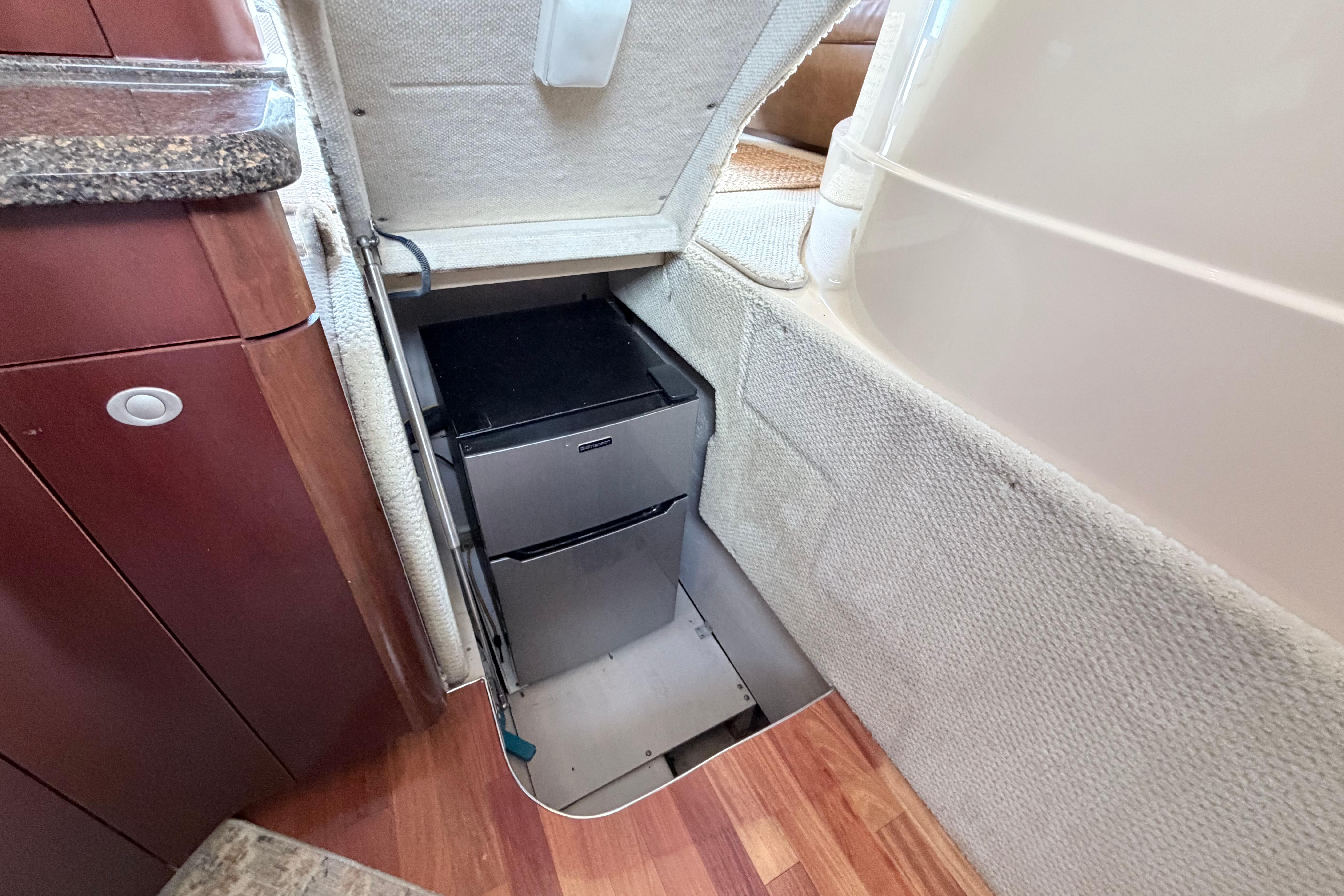 2005 Sea Ray 420 Sedan Bridge interior storage compartment with built-in refrigerator.