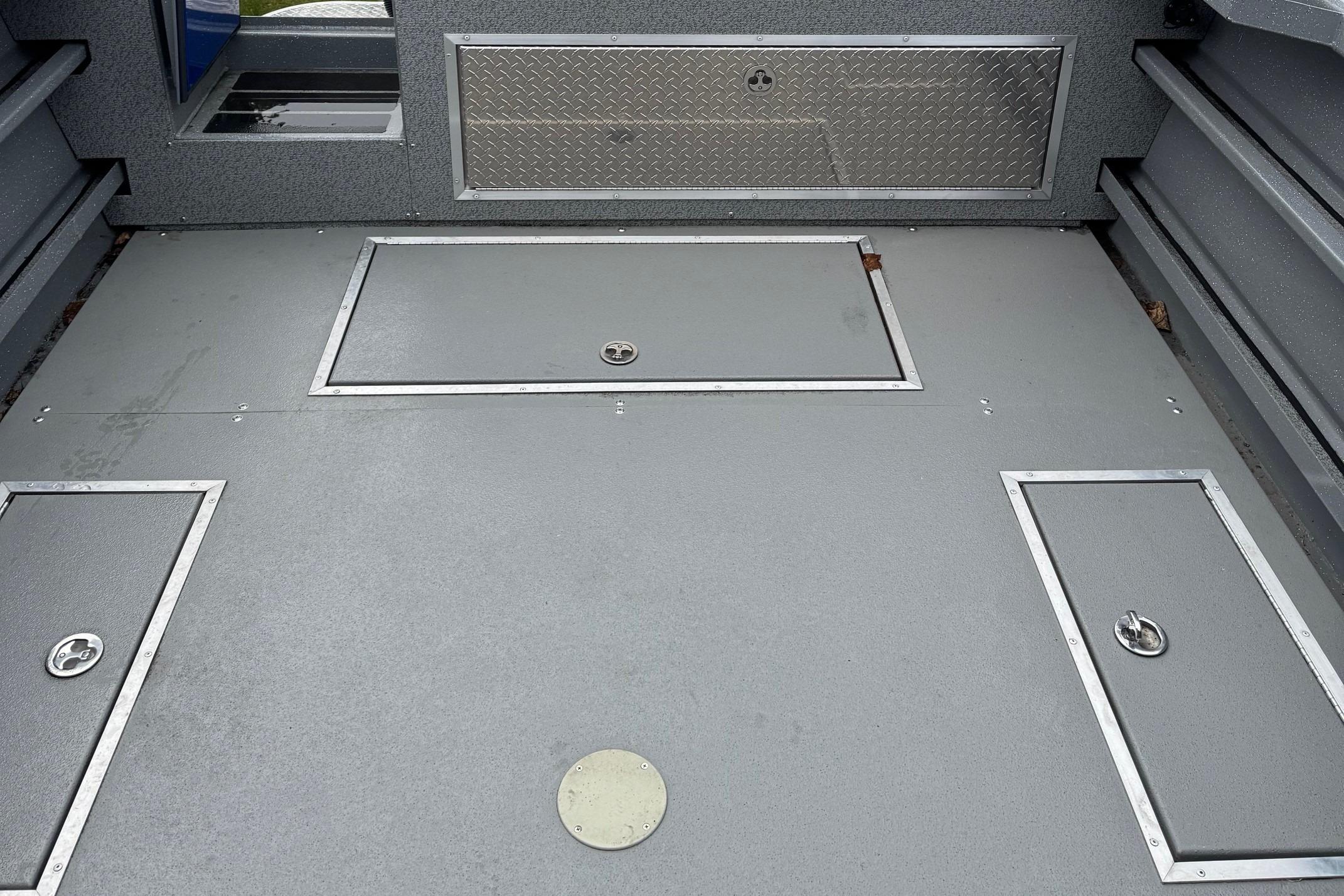 2024 Spartan 26 Maximus Pro XL boat deck with storage compartments and diamond plate accents.