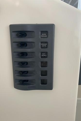 Switch panel on a boat with multiple toggle switches.