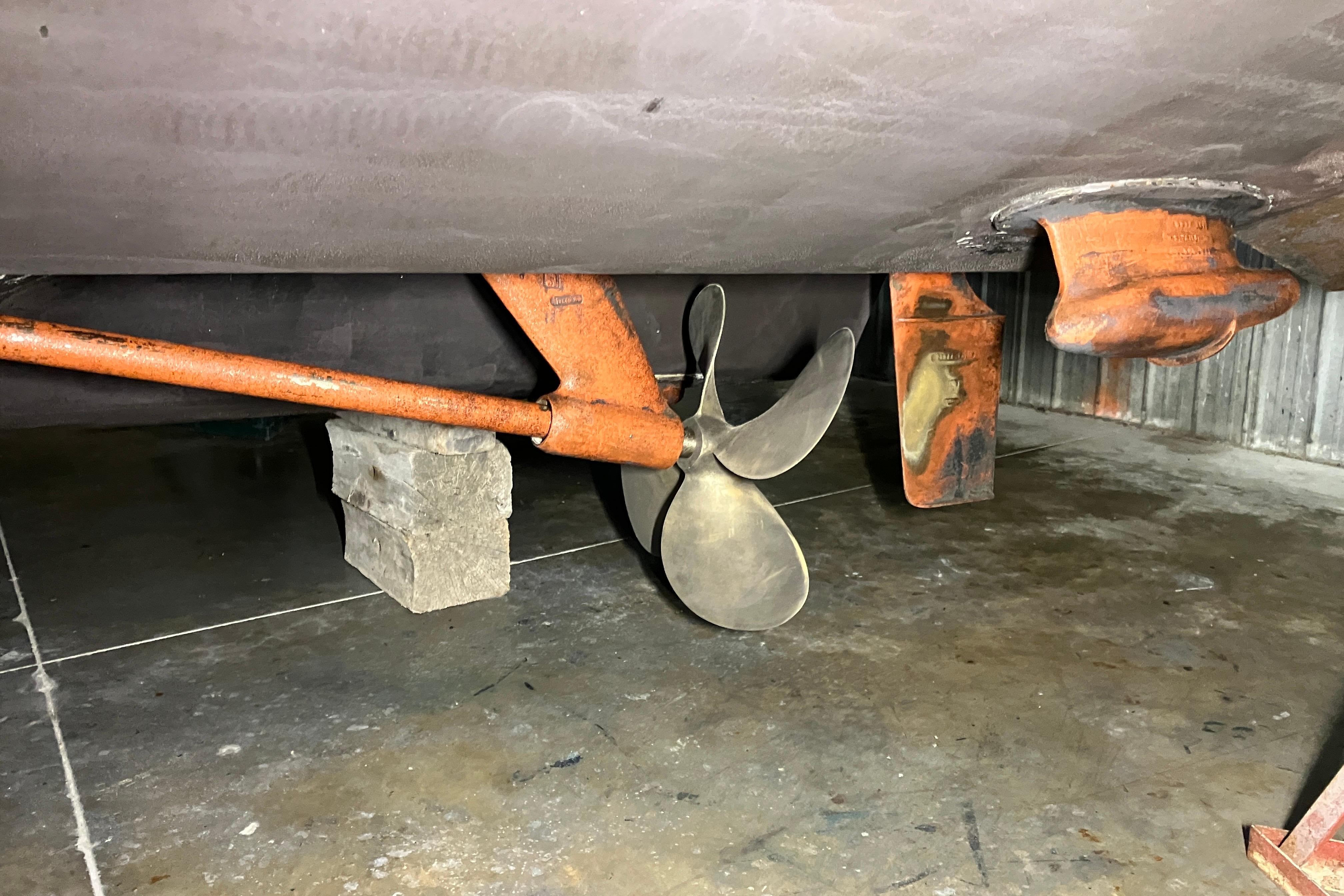 Propeller and rudder of a 2002 Sea Ray 410 Sundancer in dry dock.