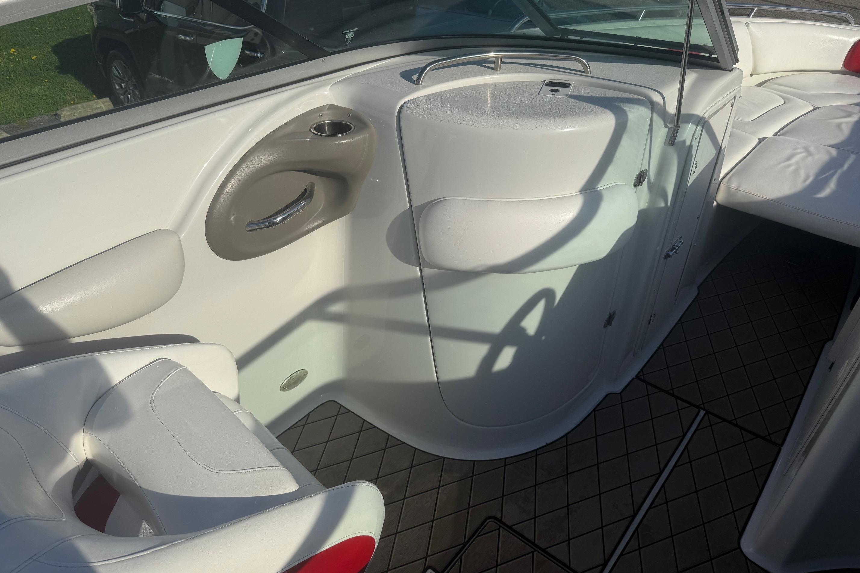 2005 Crownline 270 BR boat interior with white seating and storage compartments.
