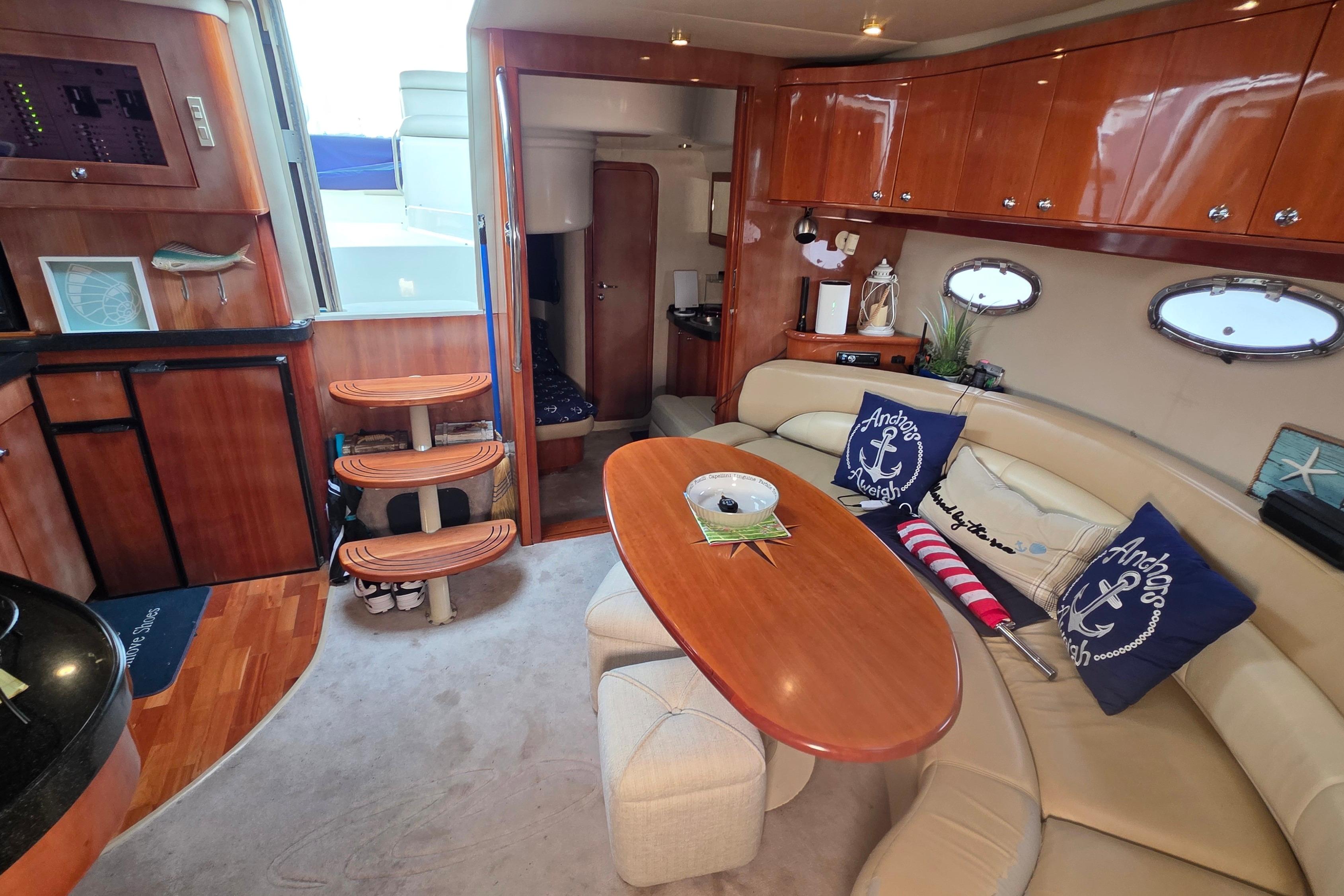Luxurious interior of 2002 Regal Commodore 4260 yacht with elegant wood finishes.