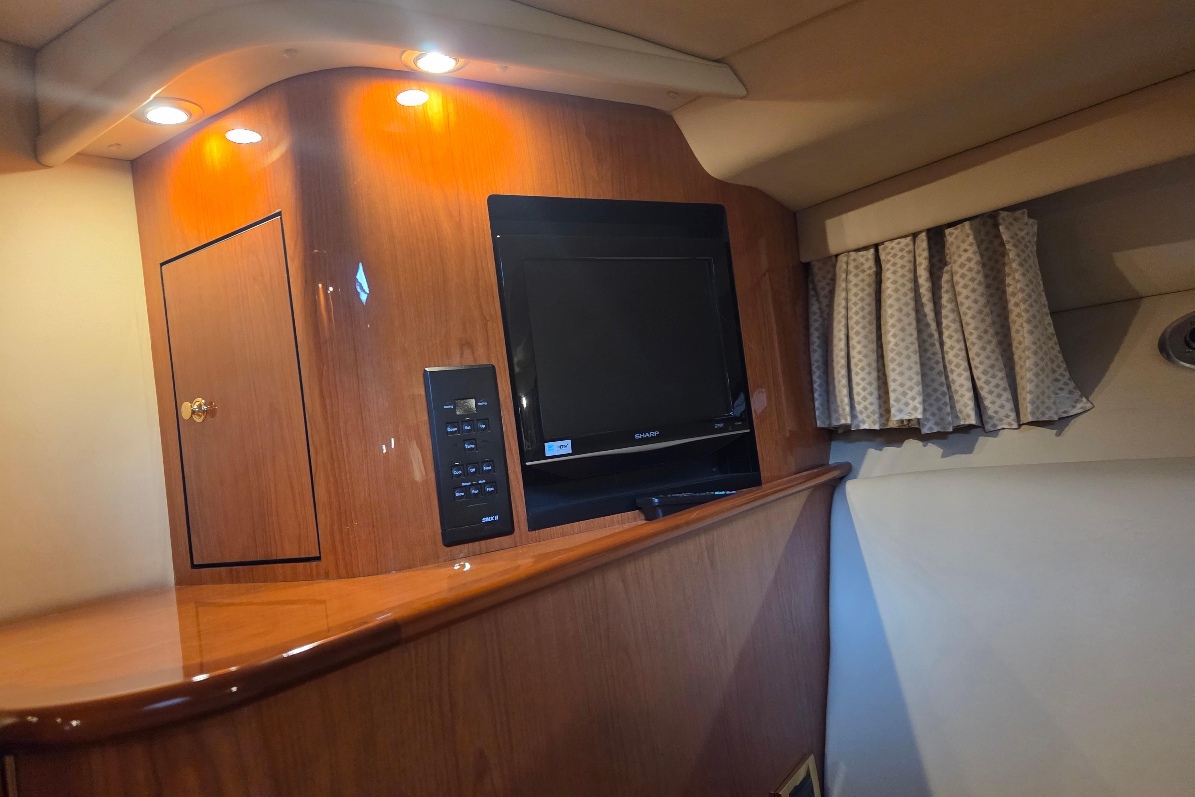 Interior of 2000 Sea Ray Sundancer 540 yacht with TV and wood paneling.