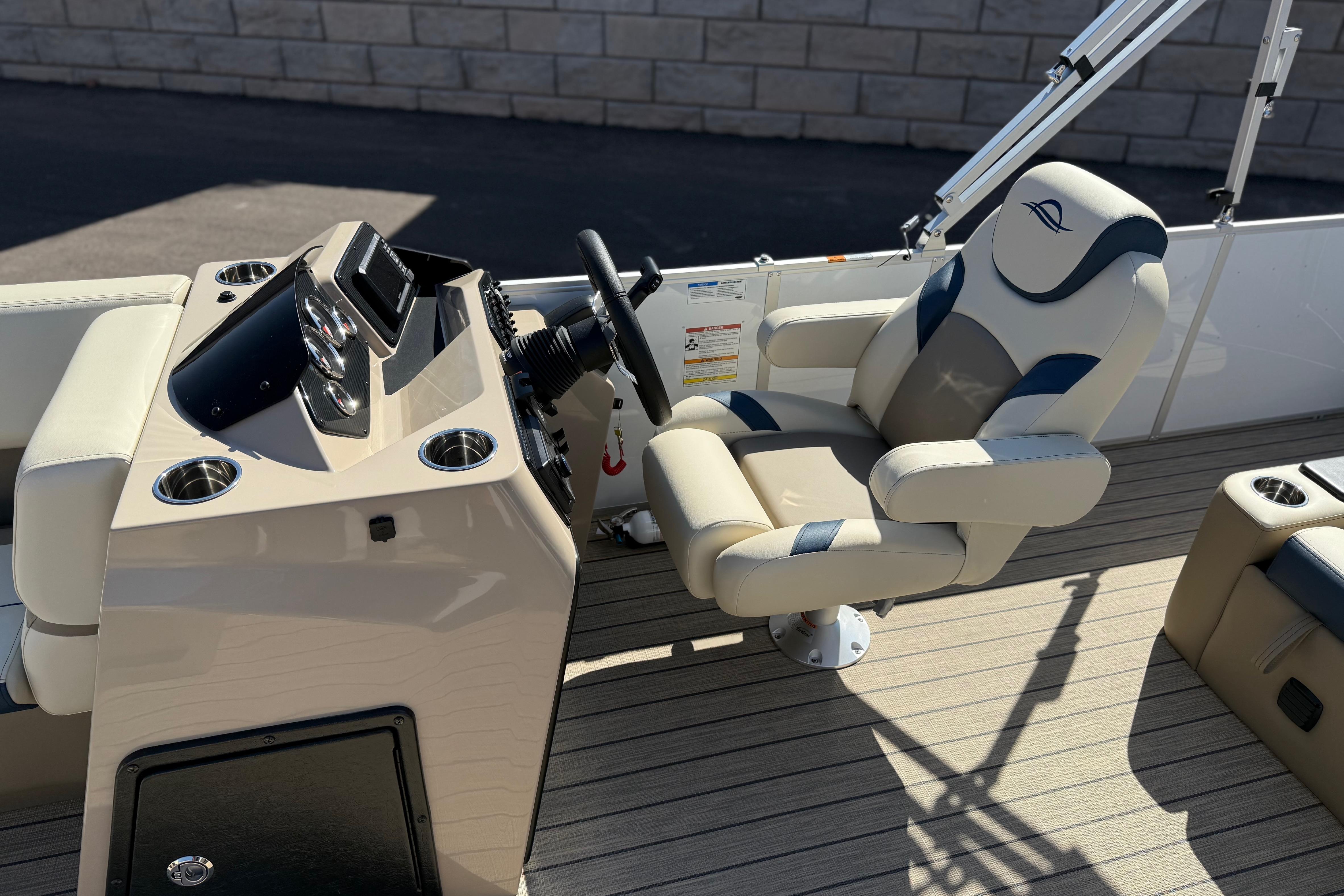 Luxurious 2026 SunCatcher Select 322SL boat interior with captain's chair and control panel.