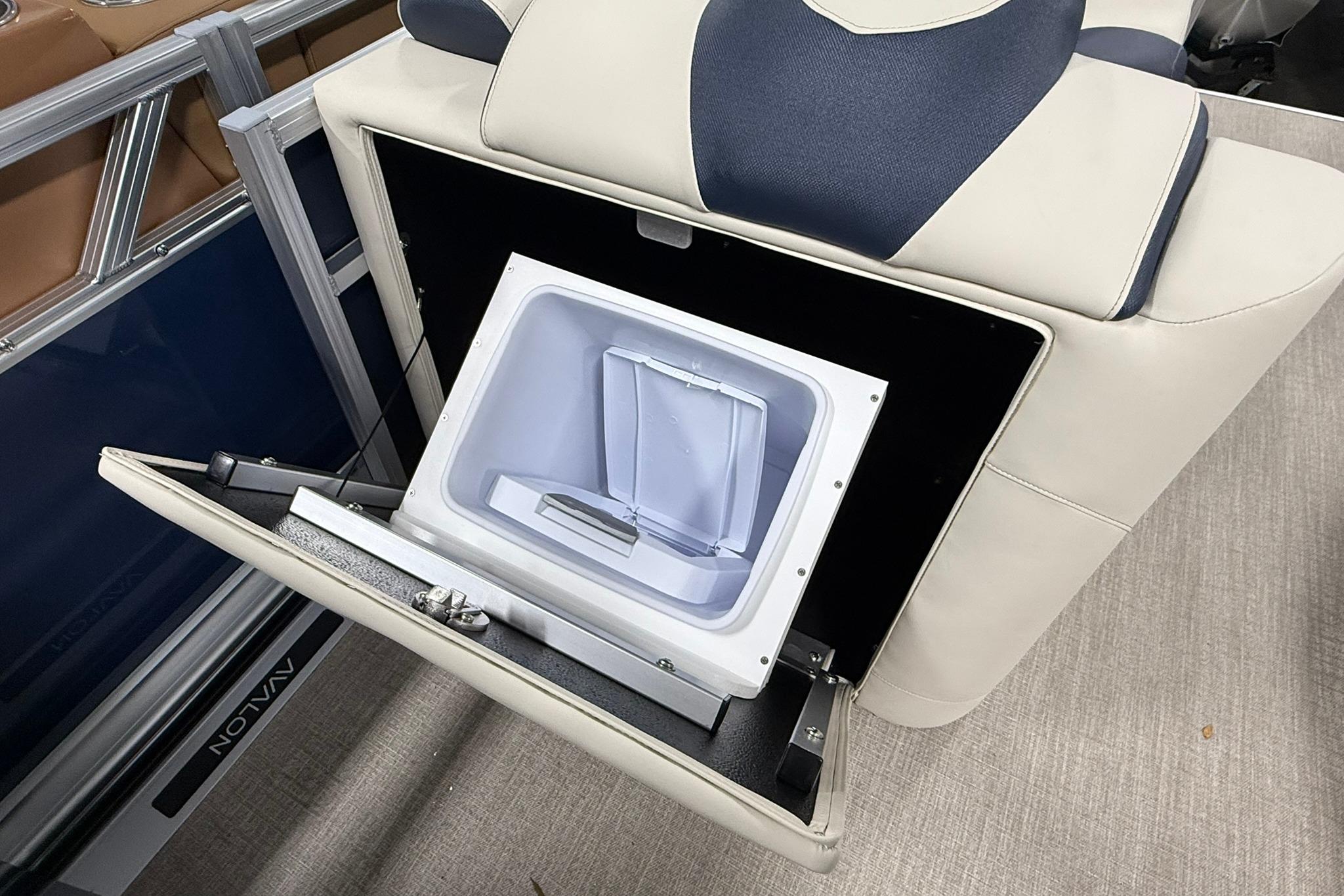 2026 Avalon LSZ Elite 21' boat seat with built-in storage compartment open.